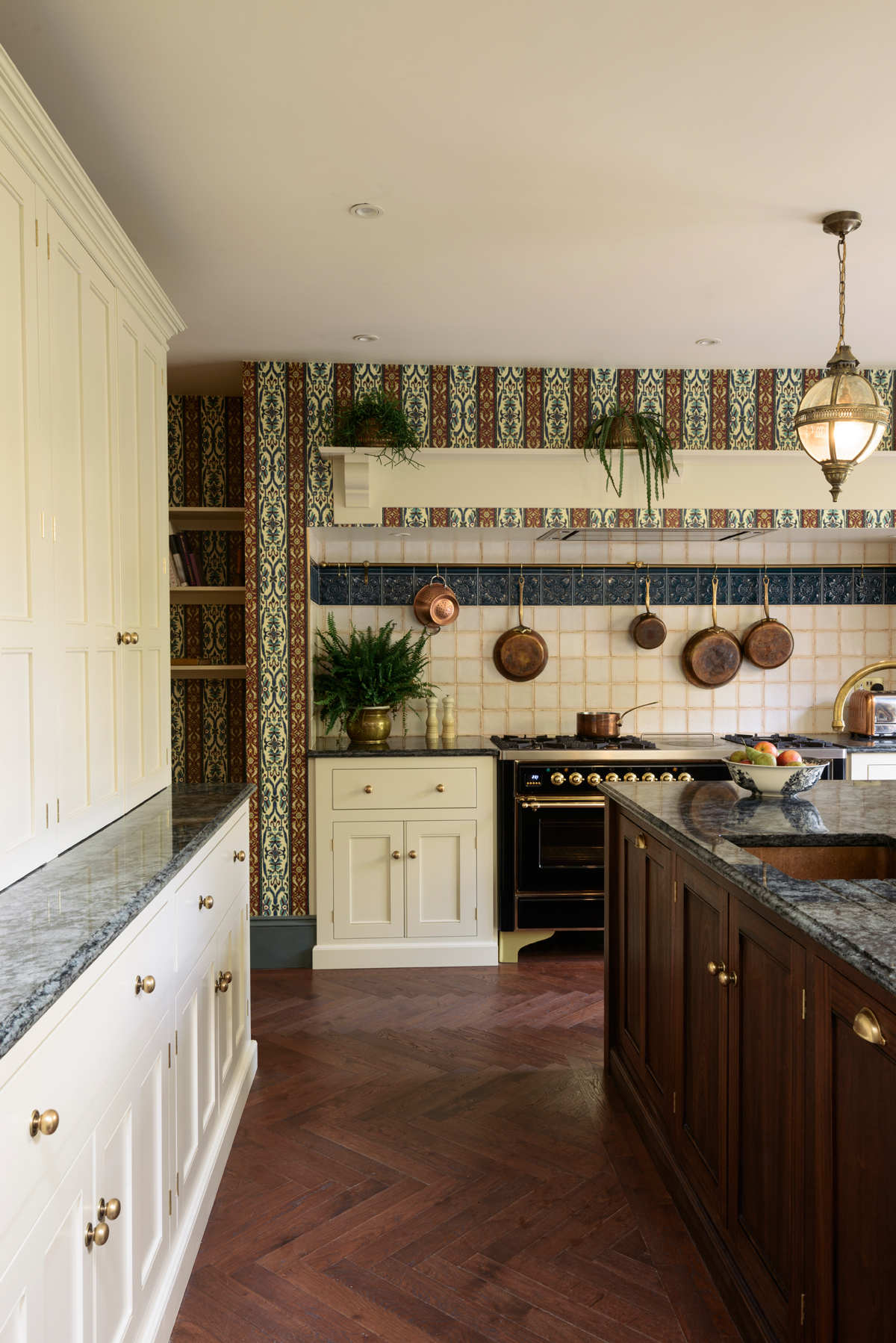 Collections of shimmering copper pans hung from an aged brass rail above the range