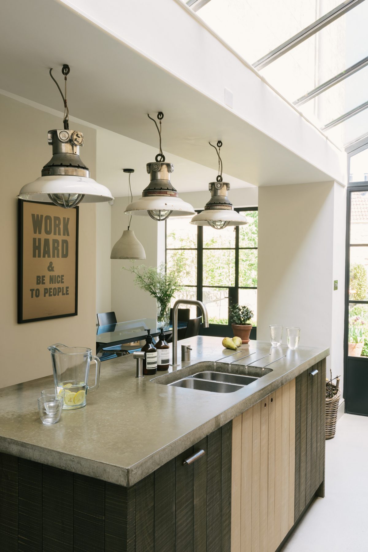 Three industrial pendant lights hang above the lovely island.