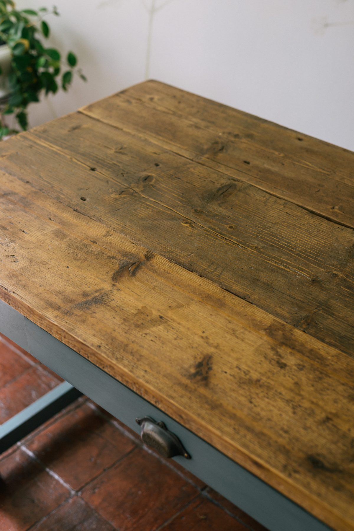 The tabletop is made from wide boards of reclaimed pine to complete the authentic, rustic look.