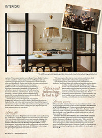 A page of a magazine, the top has a landscape image of a soft pink kitchen, below this are four paragraphs of text.