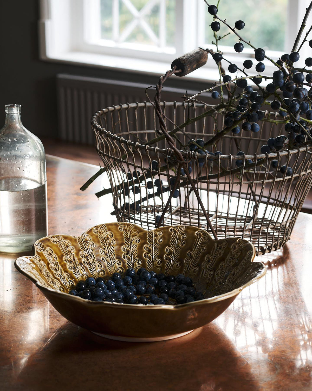 Heirloom Petal Bowl in Dark Gold Colour with blueberries on a copper worktop. TEST