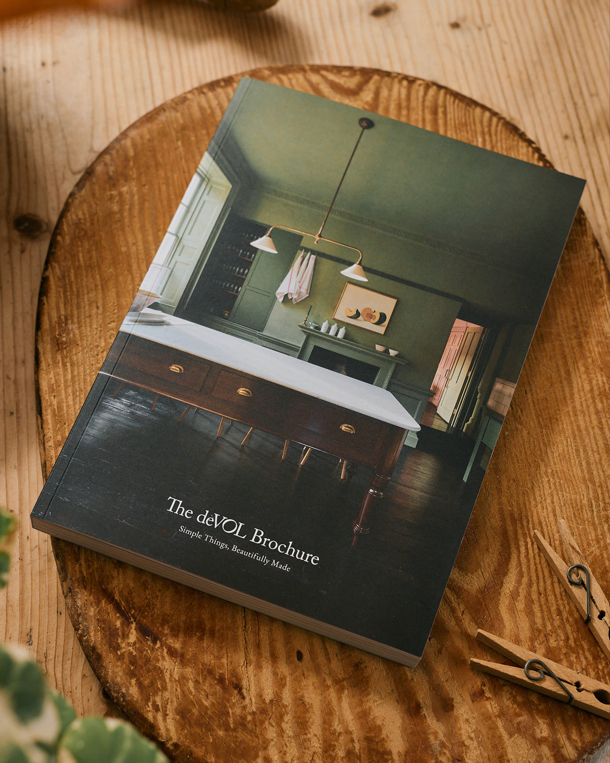 The deVOL Brochure on an antique wooden chopping board.
