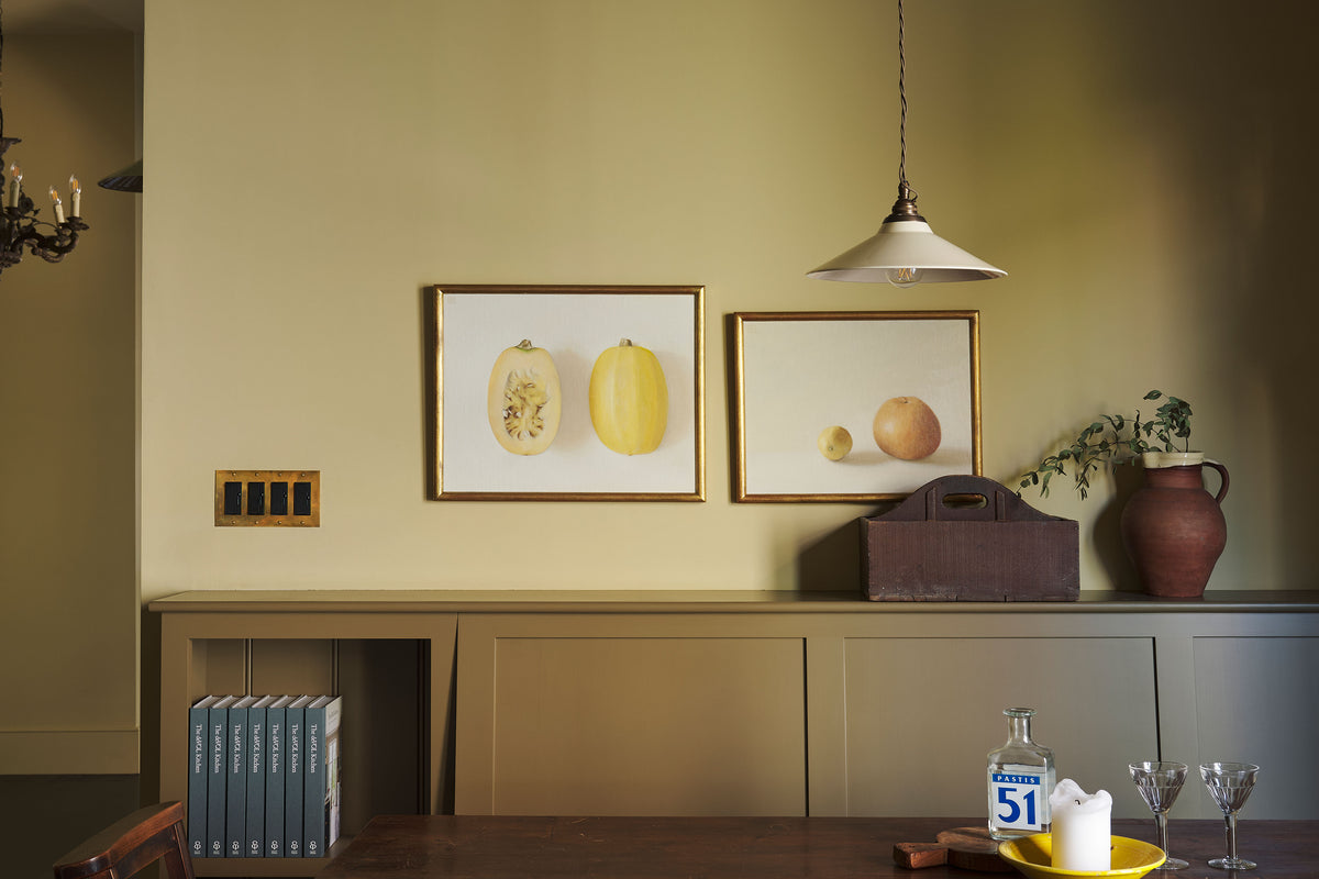 Rocker Switches with Sliders and an Heirloom Brass cover plate on lemon coloured walls.