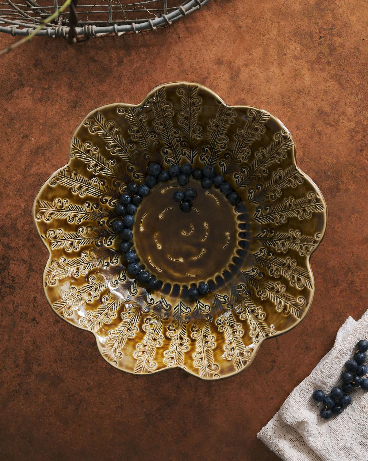 Heirloom Petal Bowl in Dark Gold Colour with blueberries on a copper worktop. TEST