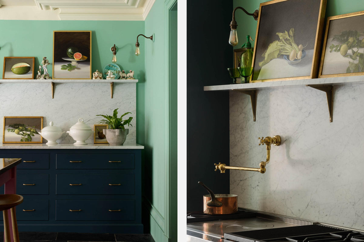 A quiet corner of a stunning, Bond Street blue kitchen features a cooker run with Arabescato marble worktop and splashback, shelf, and an aged brass pot filler tap. The room features a stunning mix of colours and character, accentuated by elegant antiques such as a collection of porcelain figures, artisan ceramics, and still paintings.