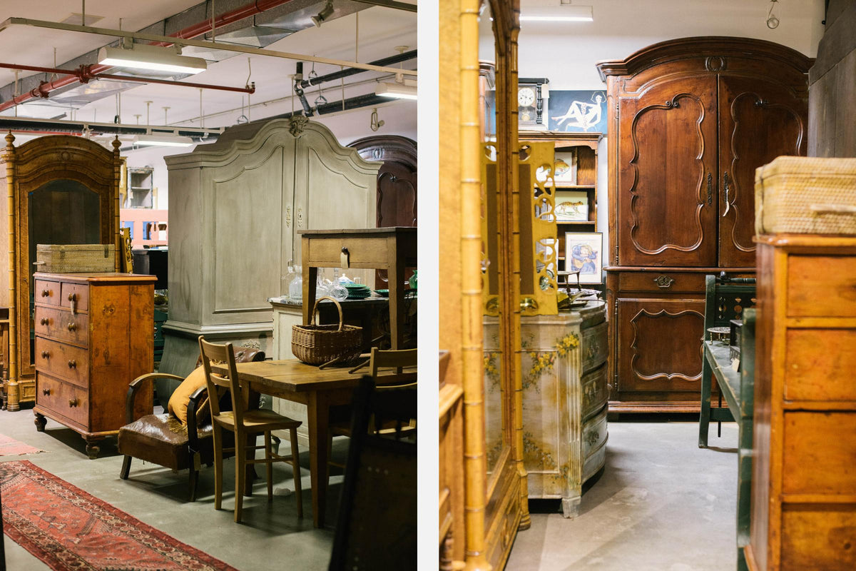 A collection of hand-picked vintage furniture from deVOL with wooden dressers, armoires, tables, and chairs.
