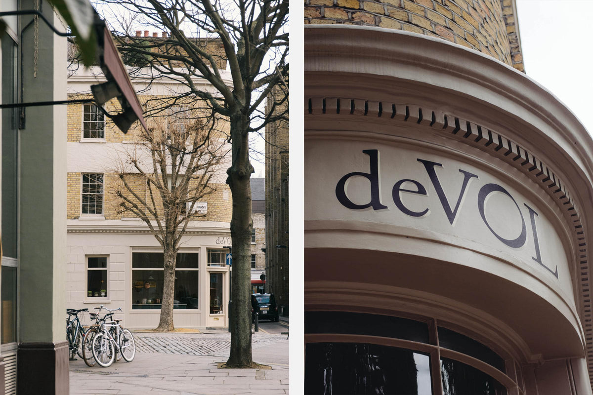 The deVOL St Johns Showroom in London is a corner, three floor, cream bricked building with strips of light beige painted exterior and a hand painted logo on top of the front door.