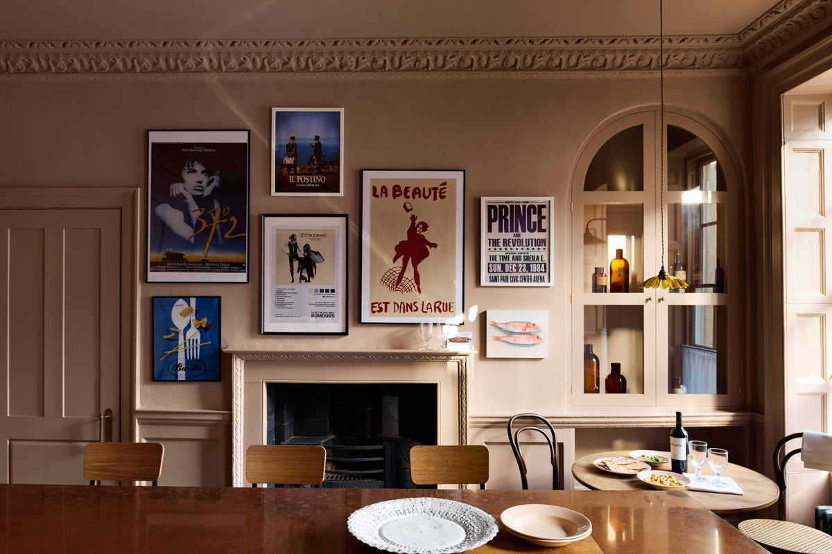 The other side of a bold and dramatic Haberdasher’s kitchen is a deVOL petite vineyard table, Bentwood café chairs, and a petite frilly chartreuse light. Adorned with artisan ceramics, a delicious bottle of wine, drinking glasses, hors d’oeuvres, quirky framed illustrations and posters, and labelled glass jars, this space creates a local bistro bar atmosphere in Manhattan.