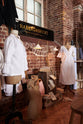 A close and oblique look at the Grand Tour library lamp and the plug-in porcelain beaker lamp reveals features from the handsome range of oak furniture and lighting from the deVOL Haberdasher’s collection. Adorned with vintage furniture and items, dressmaker mannequins, and 1900s tailor tools, this space creates a beautiful homage to the English gentlemen’s haberdashery inspiration in a bricked wall showroom.