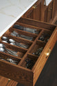 A close-up of a cutlery insert with silver cutlery as part of a bespoke 3.5-metre-long dairy table.