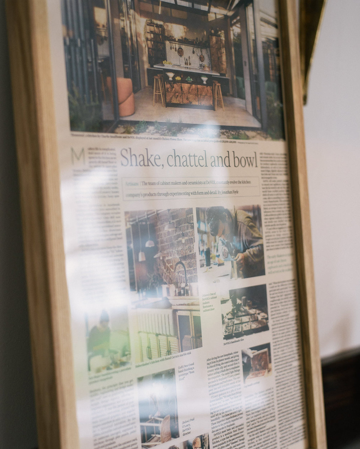 A close-up image of a framed newspaper full page about deVOL.