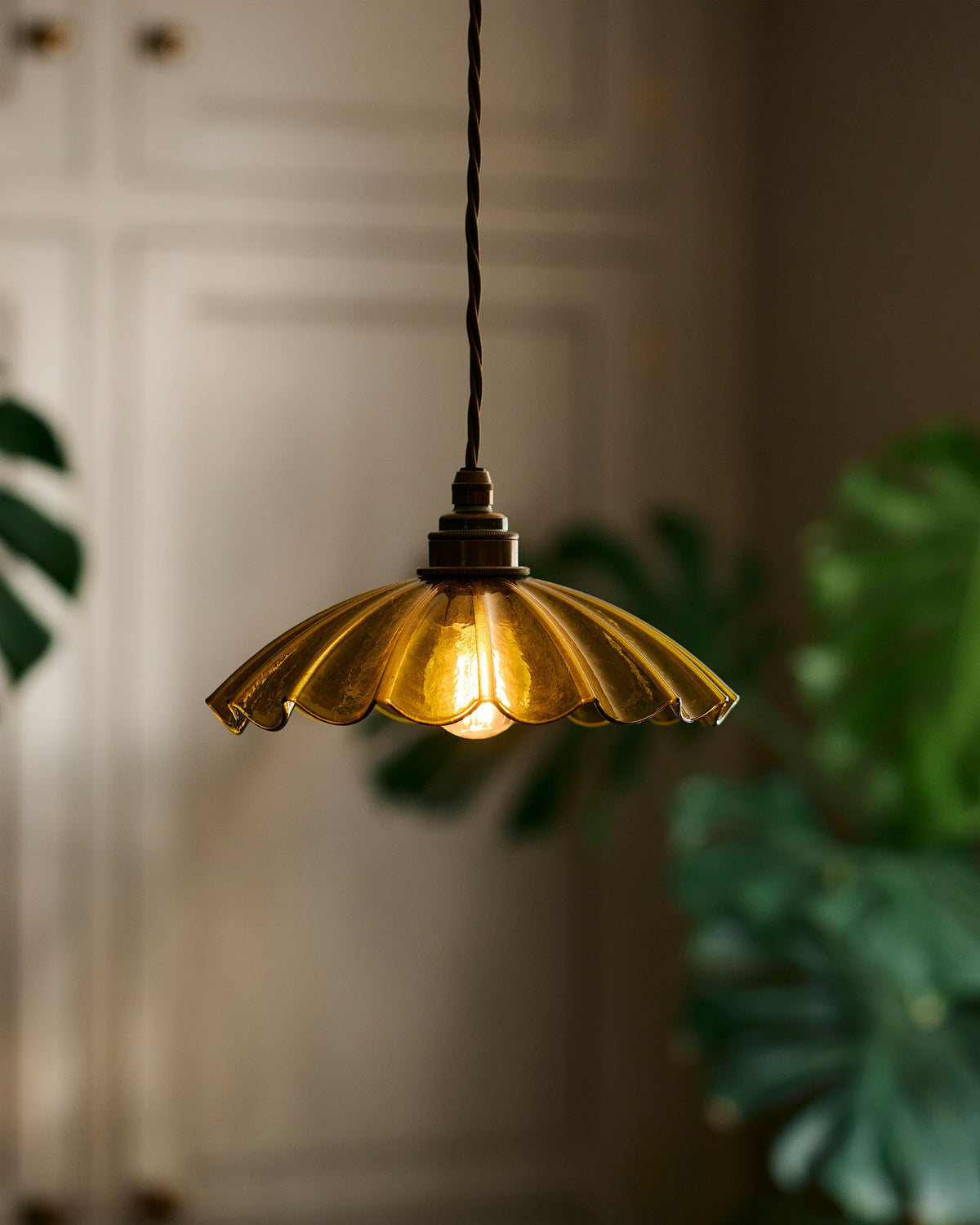 A close up image of the frilly glass chartreuse pendant light.