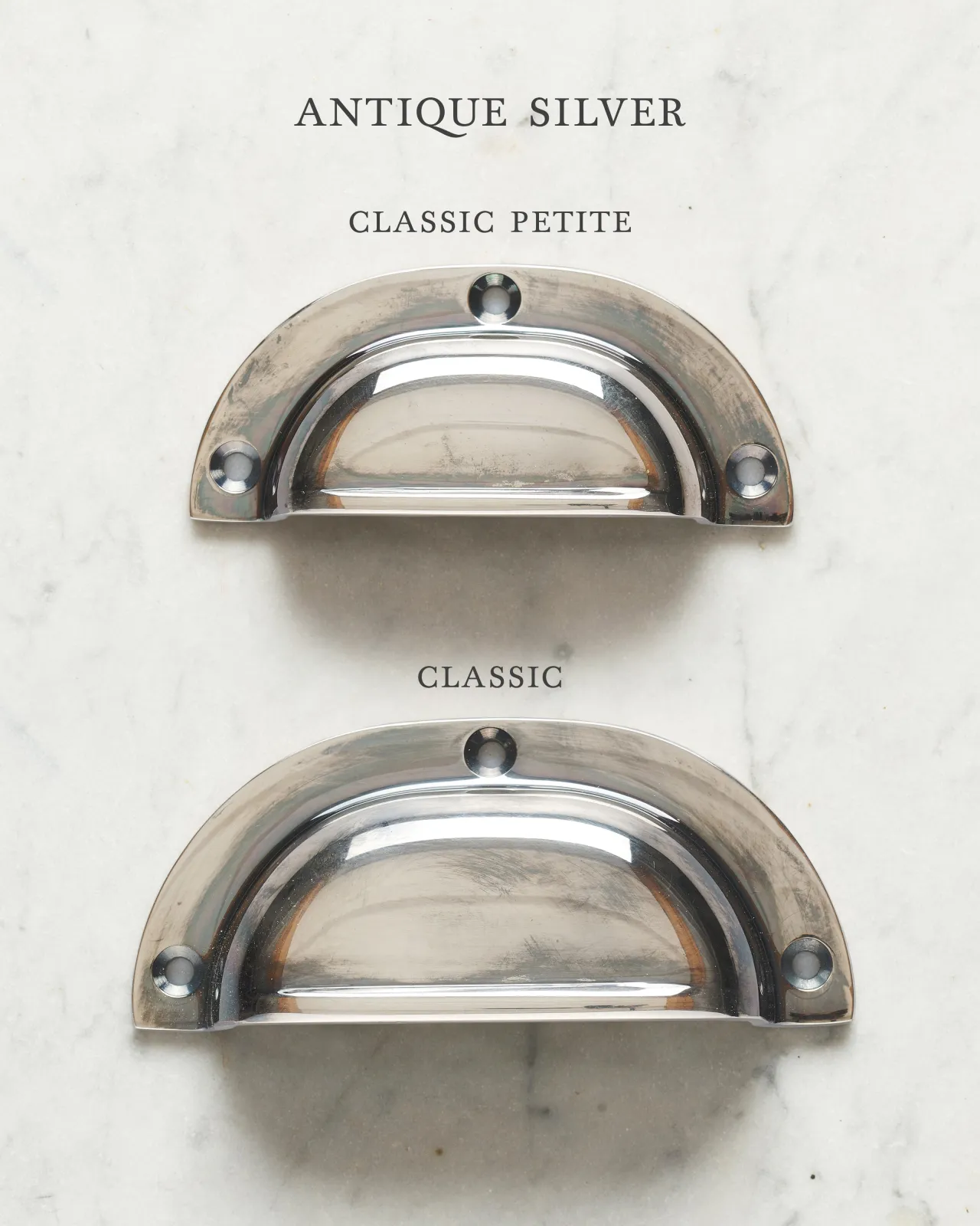 Two classic cup handles for a kitchen cupboard or drawer with a tarnished silver finish. There is a large and a small size.