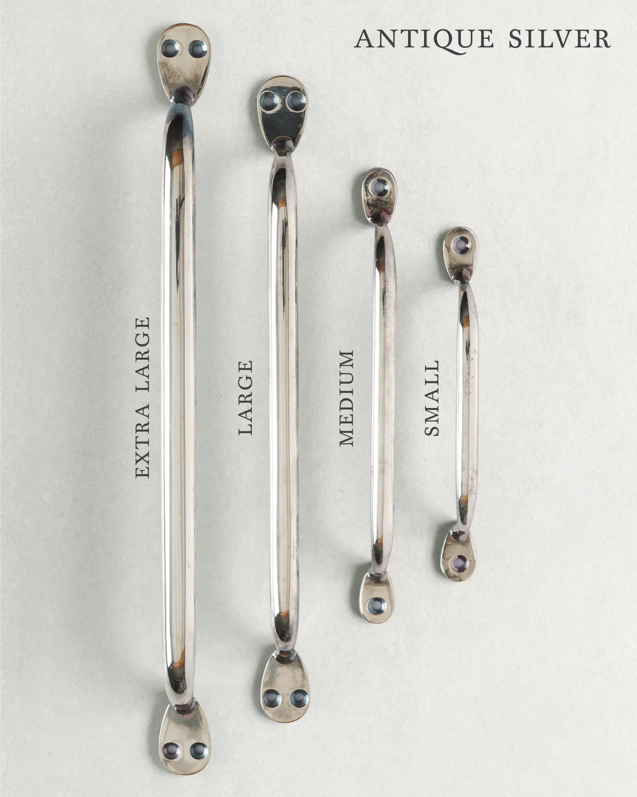 A collection of four classic pull handles for a kitchen cupboard or drawer with an antique silver finish. They range in size from ‘Extra Large’ to ‘Small’.