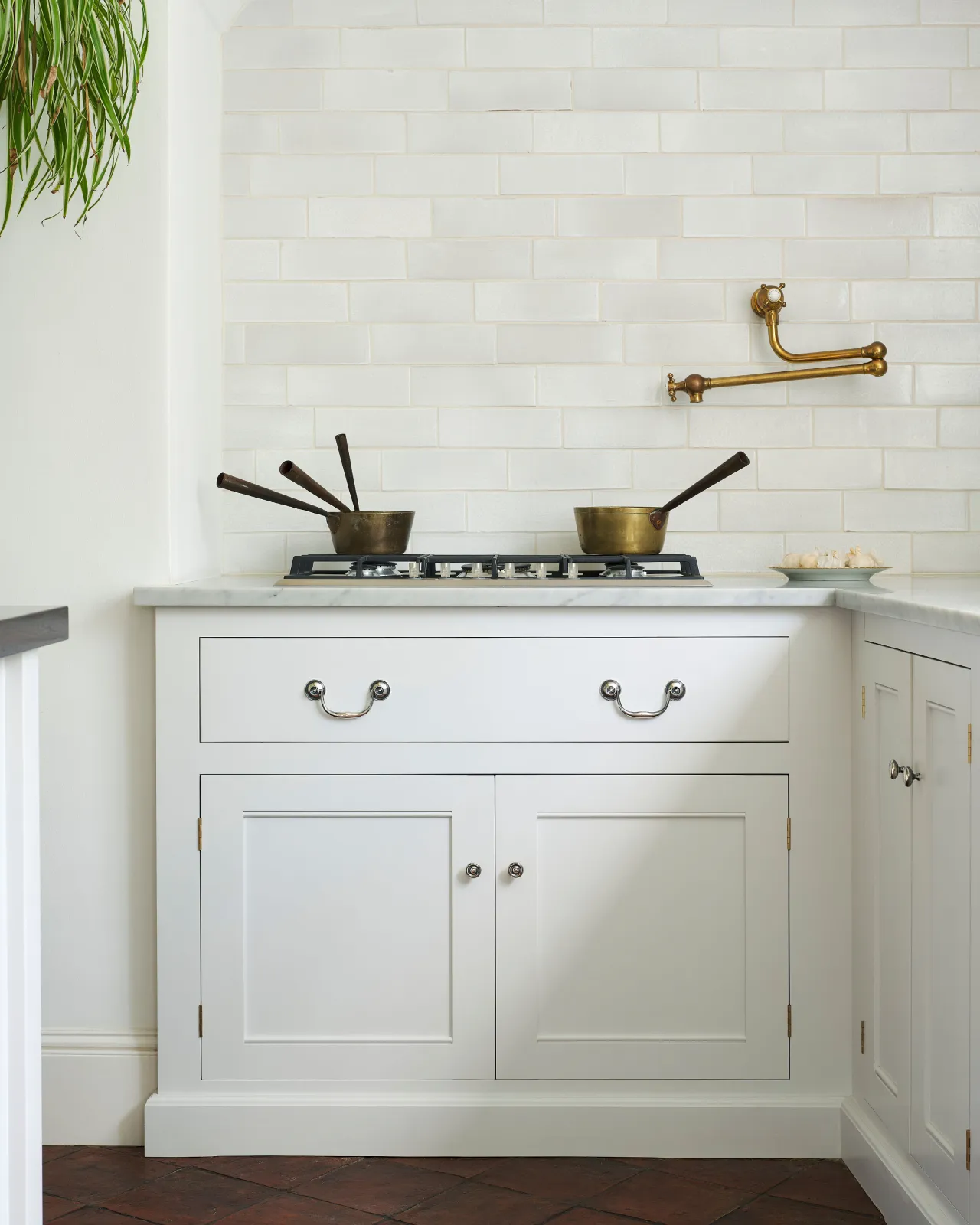 A front-on view of an elegant Georgian-style silver swing handle for kitchen cupboard drawers.