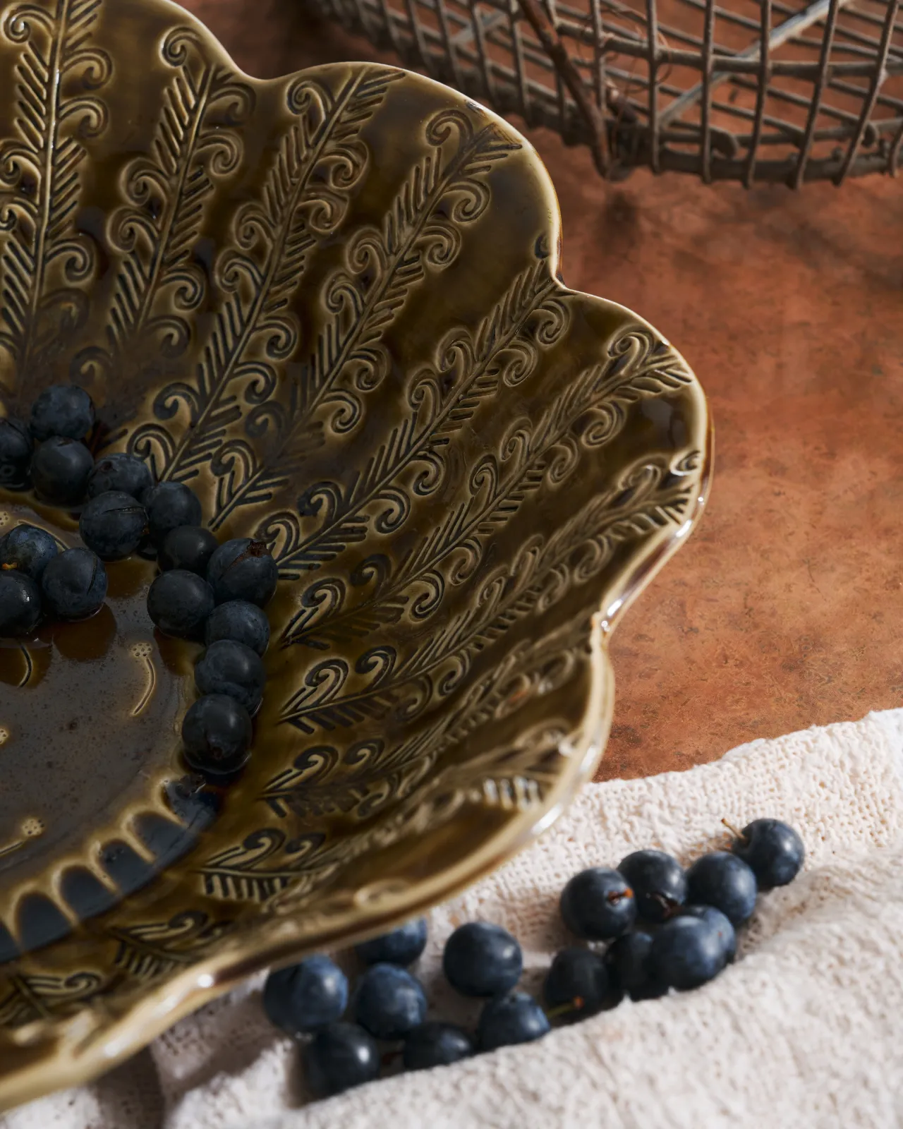 Heirloom Petal Bowl in Dark Gold Colour with blueberries on a copper worktop.