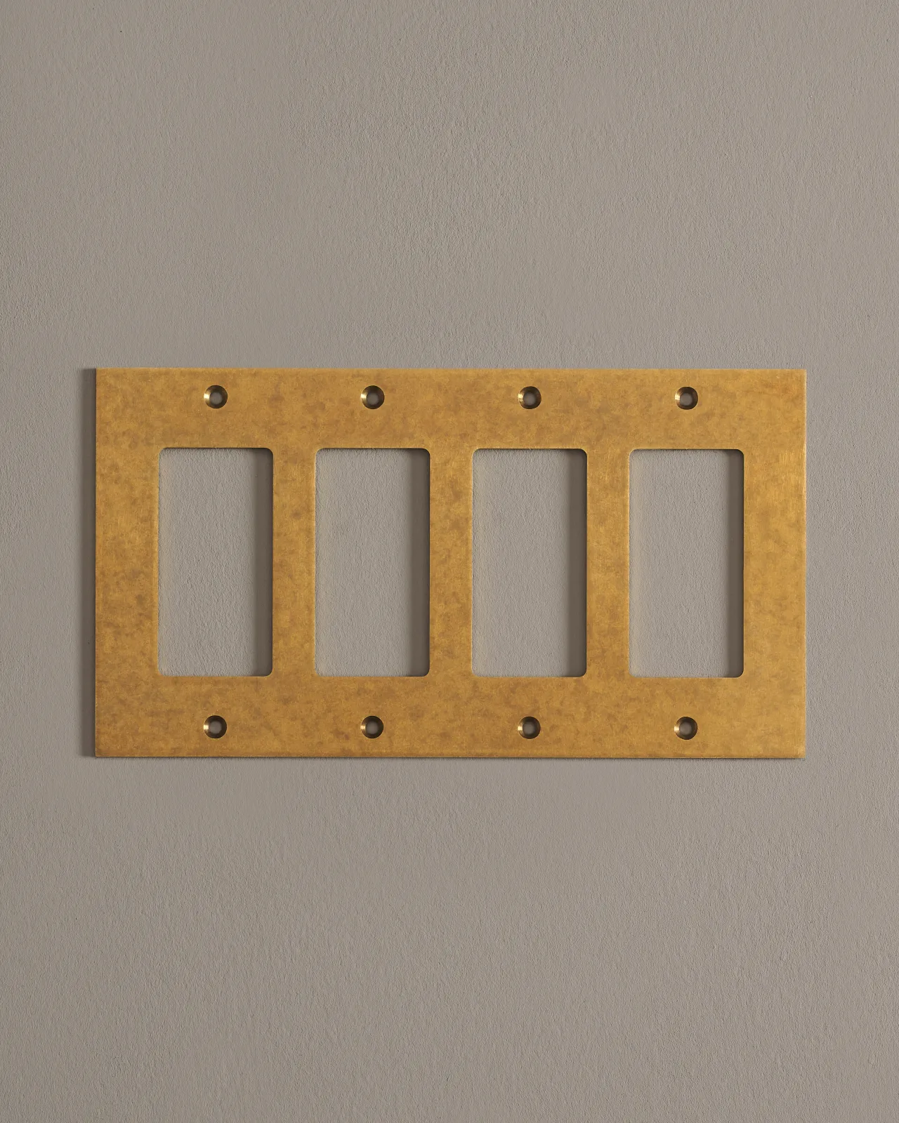 A front on shot of a cover plate in aged brass finish.