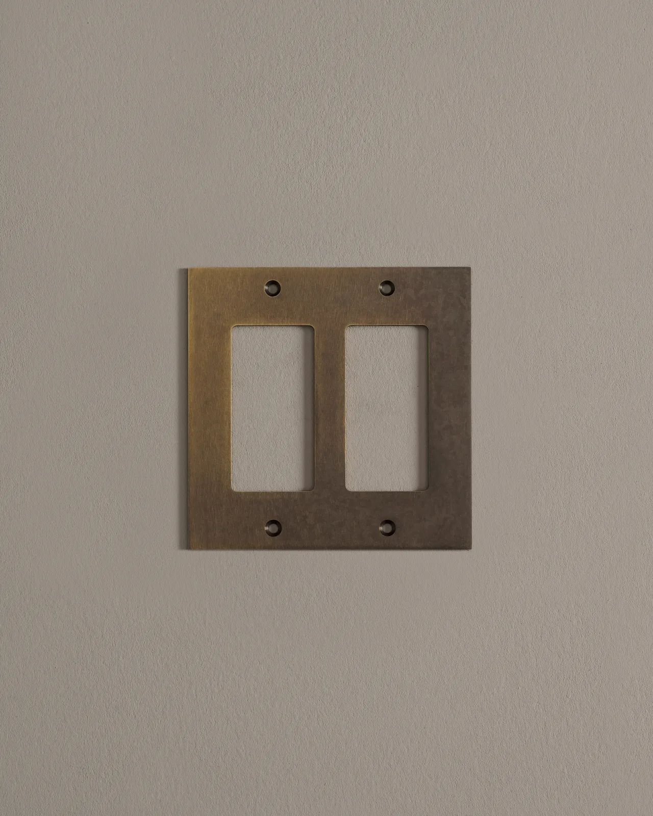 a front on shot of the decora cover plate in oxidised brass finish.