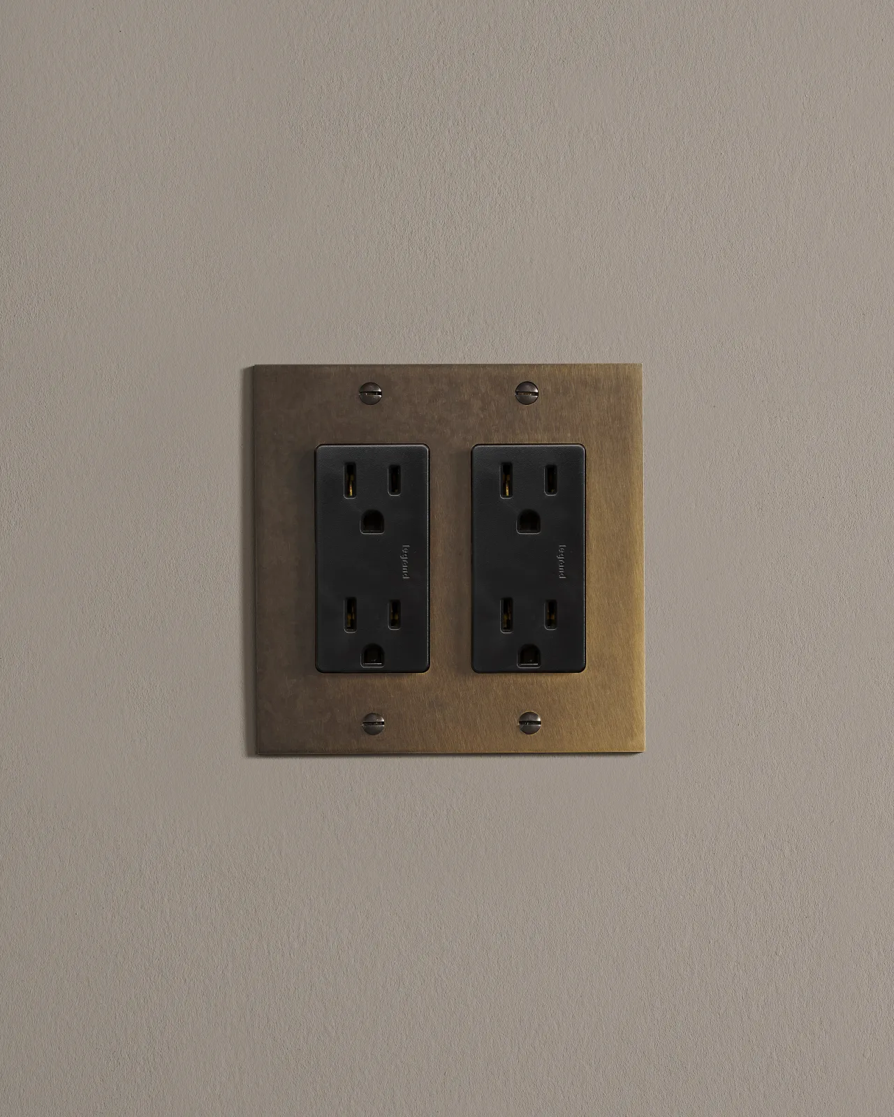 a front on shot of the standard outlet on an oxidised brass plate.