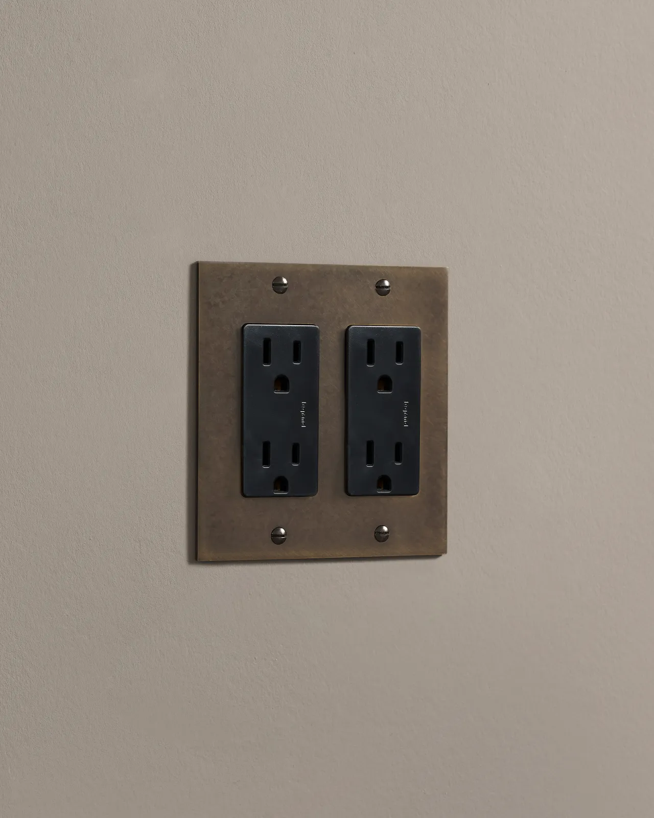 a side on shot of the standard outlet on an oxidised brass plate.