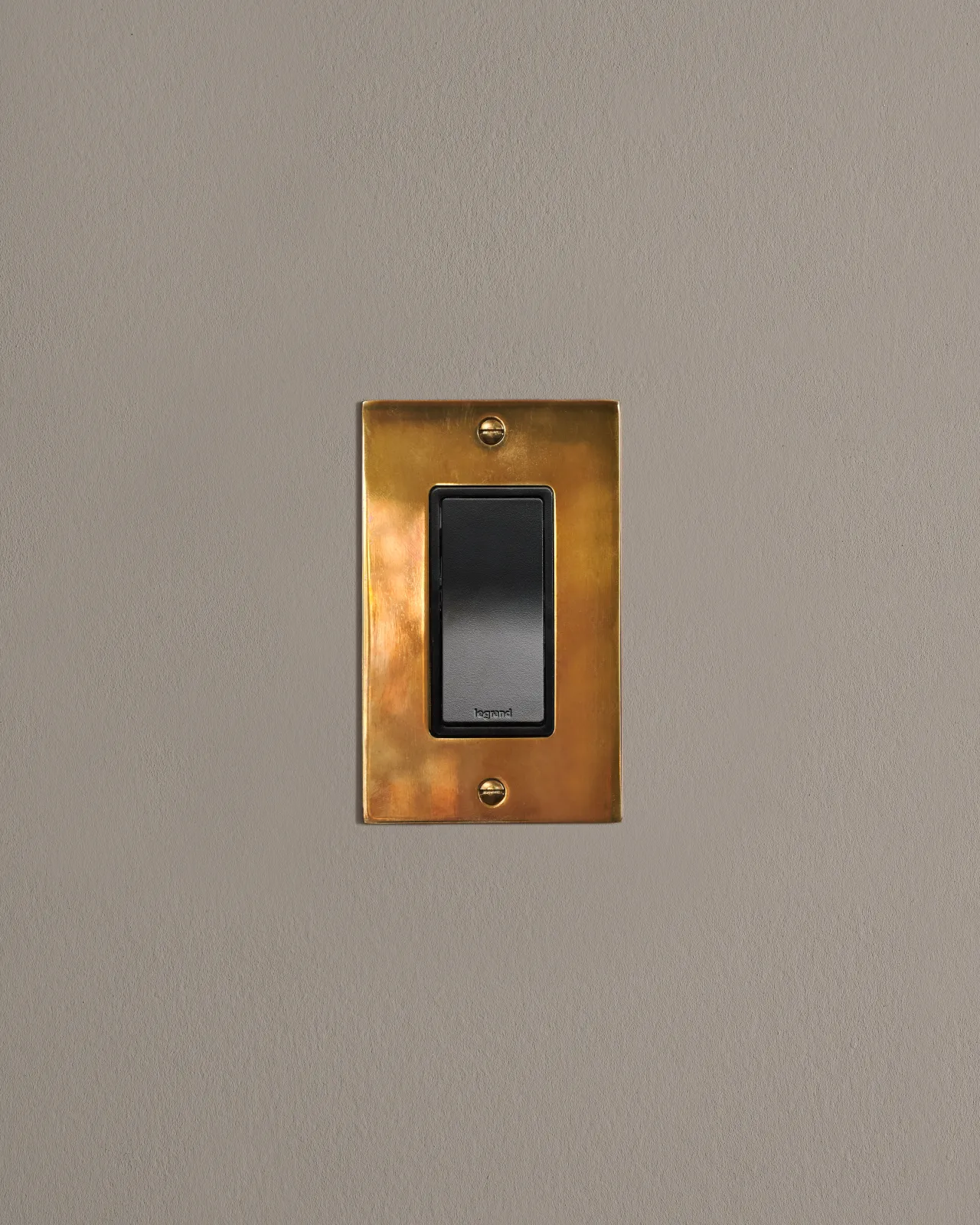a front on shot of the rocker switch on an heirloom brass plate.