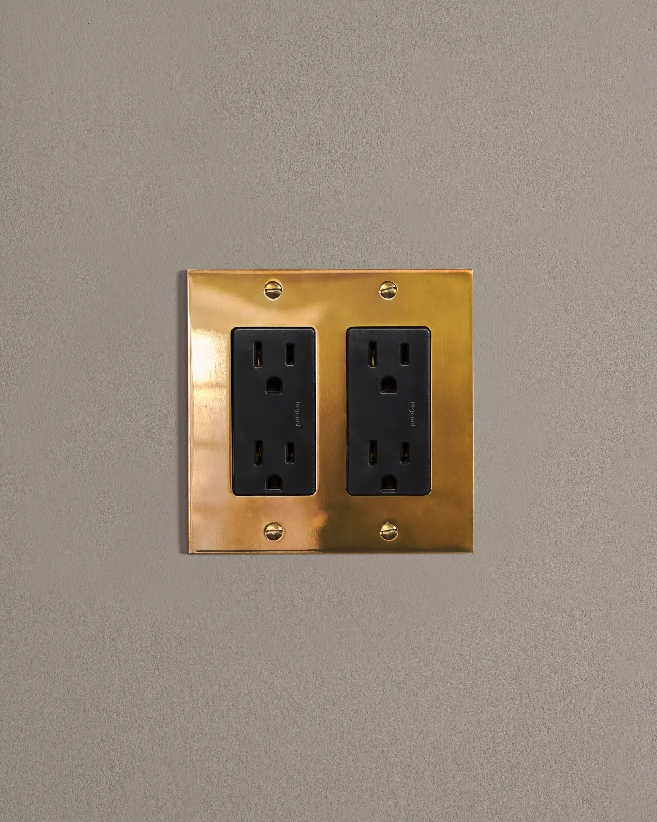 a front on shot of the standard outlet on an heirloom brass plate.