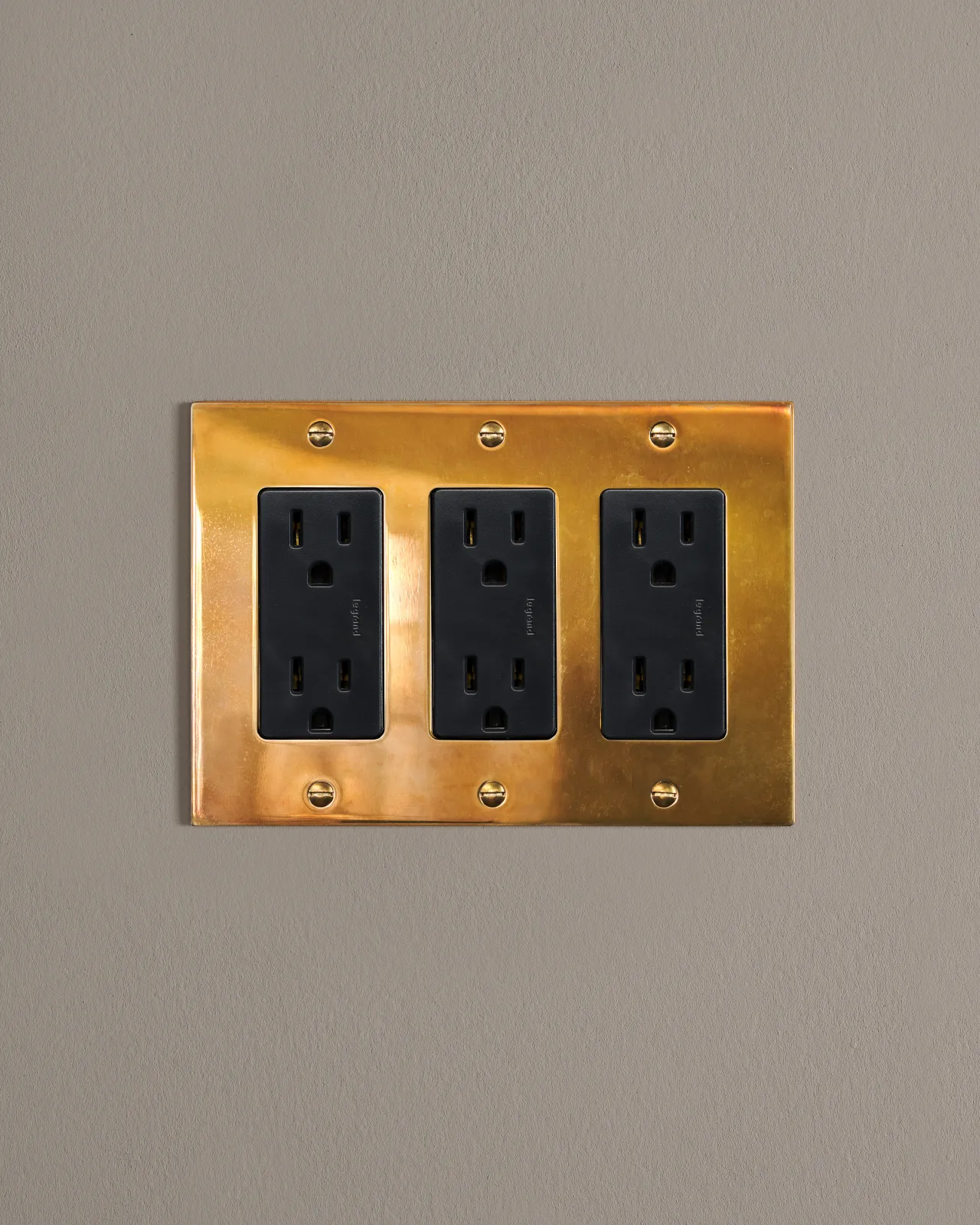 a front on shot of the standard outlet on an heirloom brass plate.