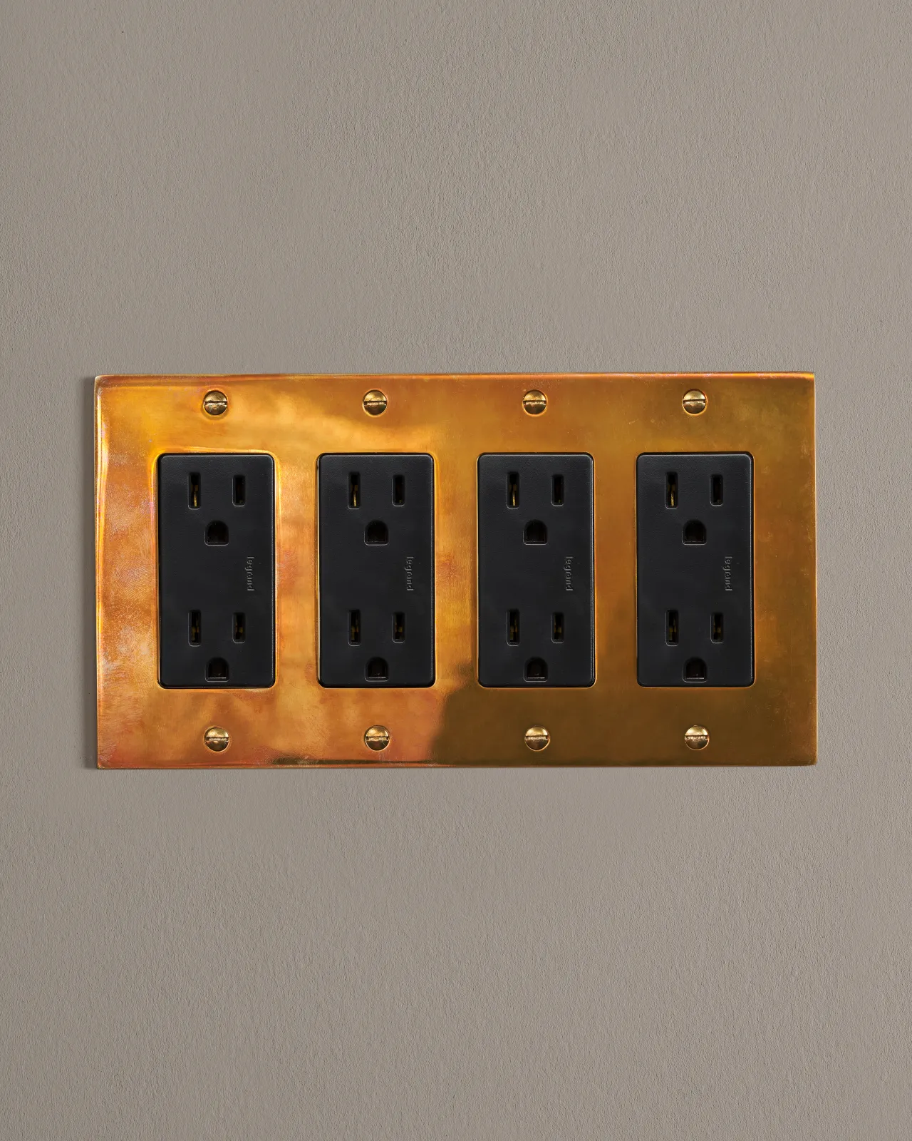 a front on shot of the standard outlet on an heirloom brass plate.
