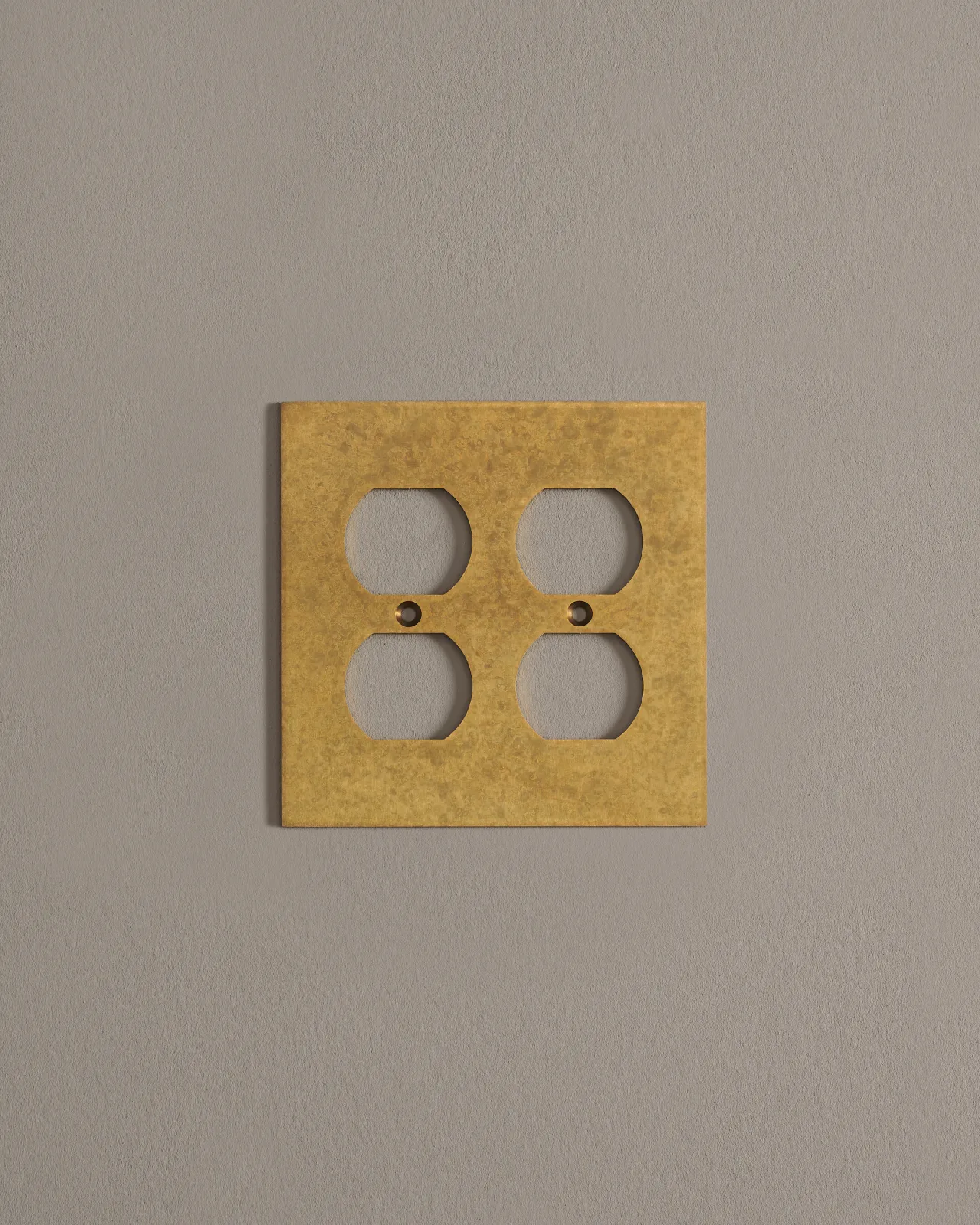 a front on shot of the duplex outlet cover plate in aged brass.