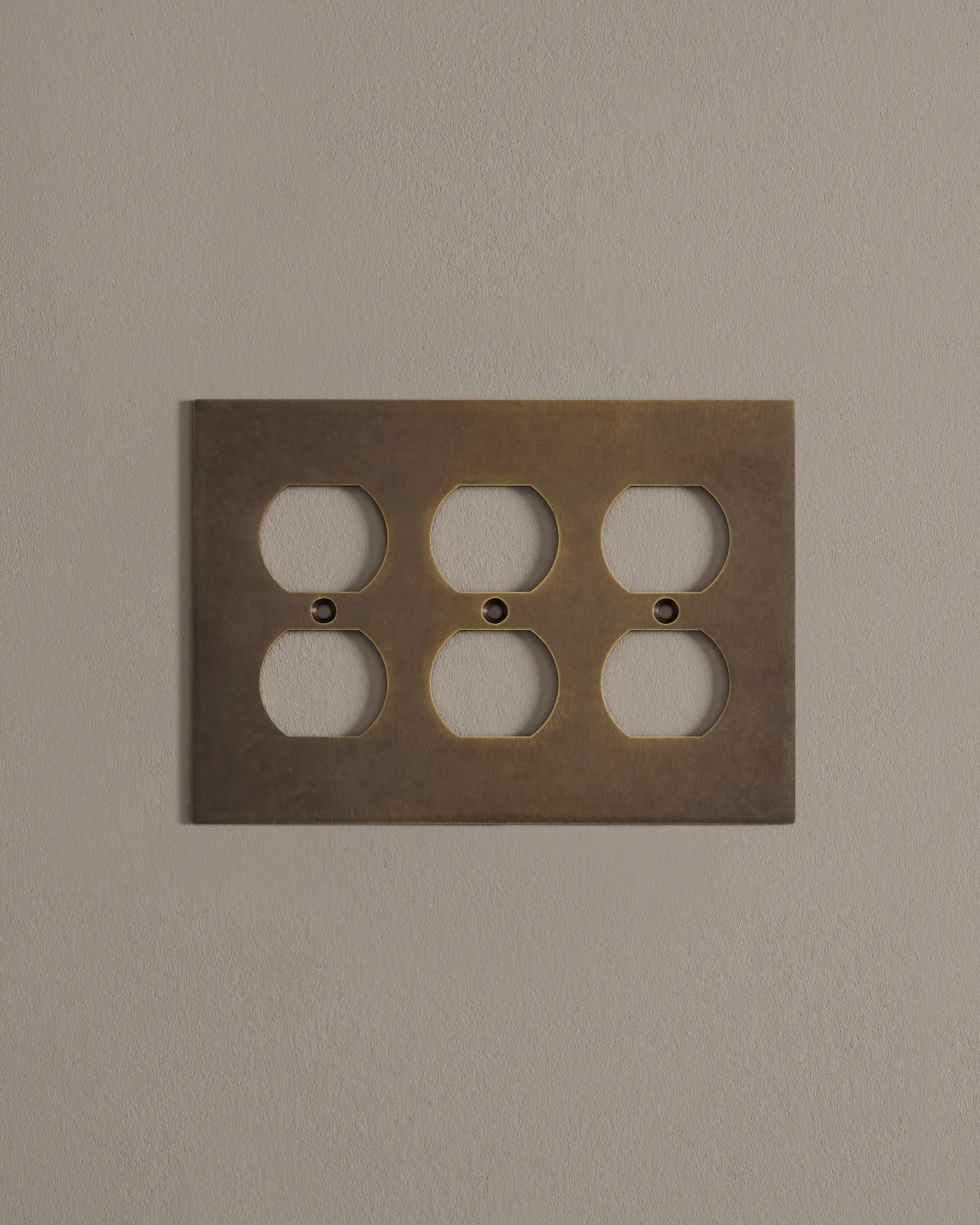 a front on shot of the duplex outlet cover plate in an oxidised brass finish.