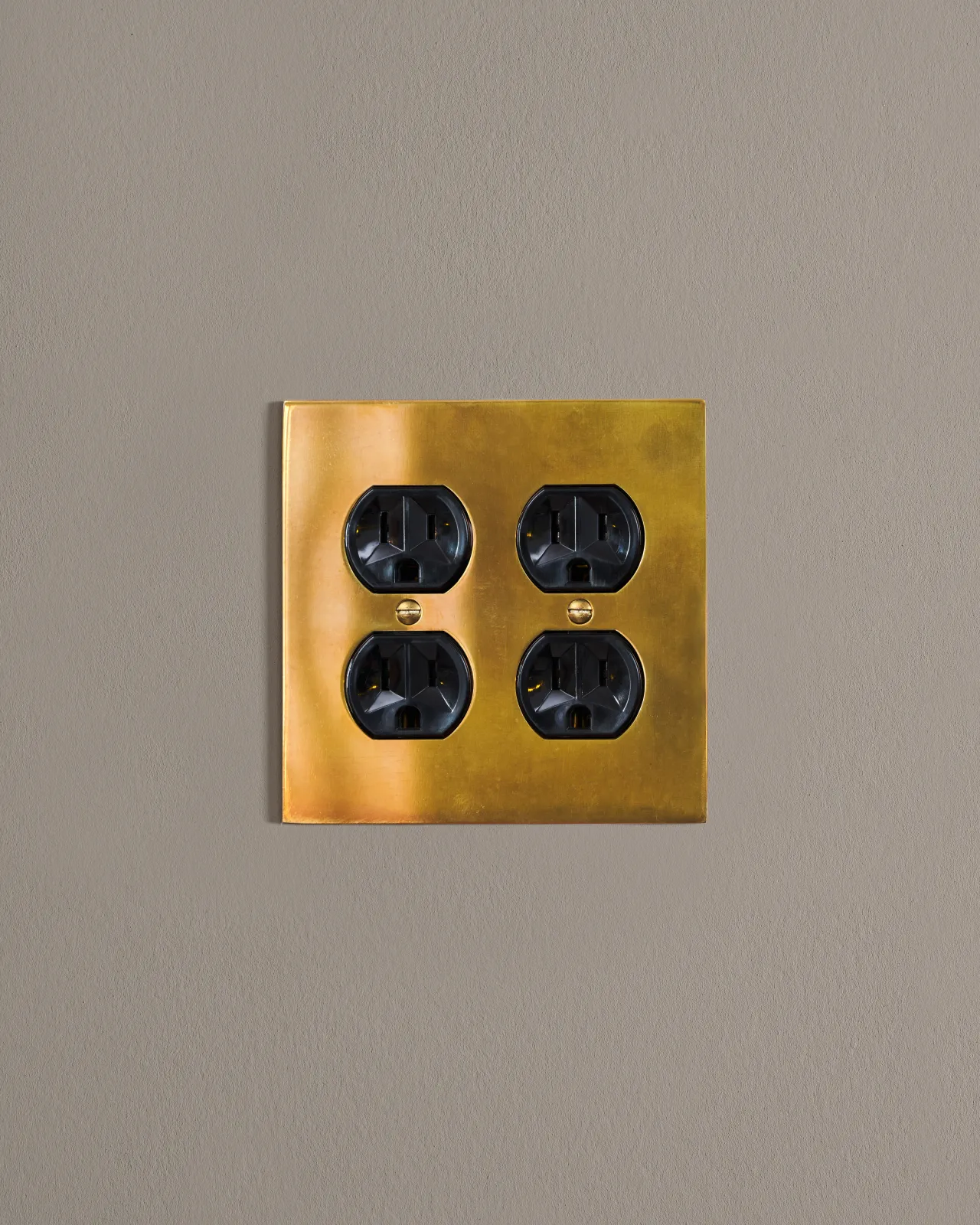 a front on shot of the duplex outlet on an heirloom brass cover plate.