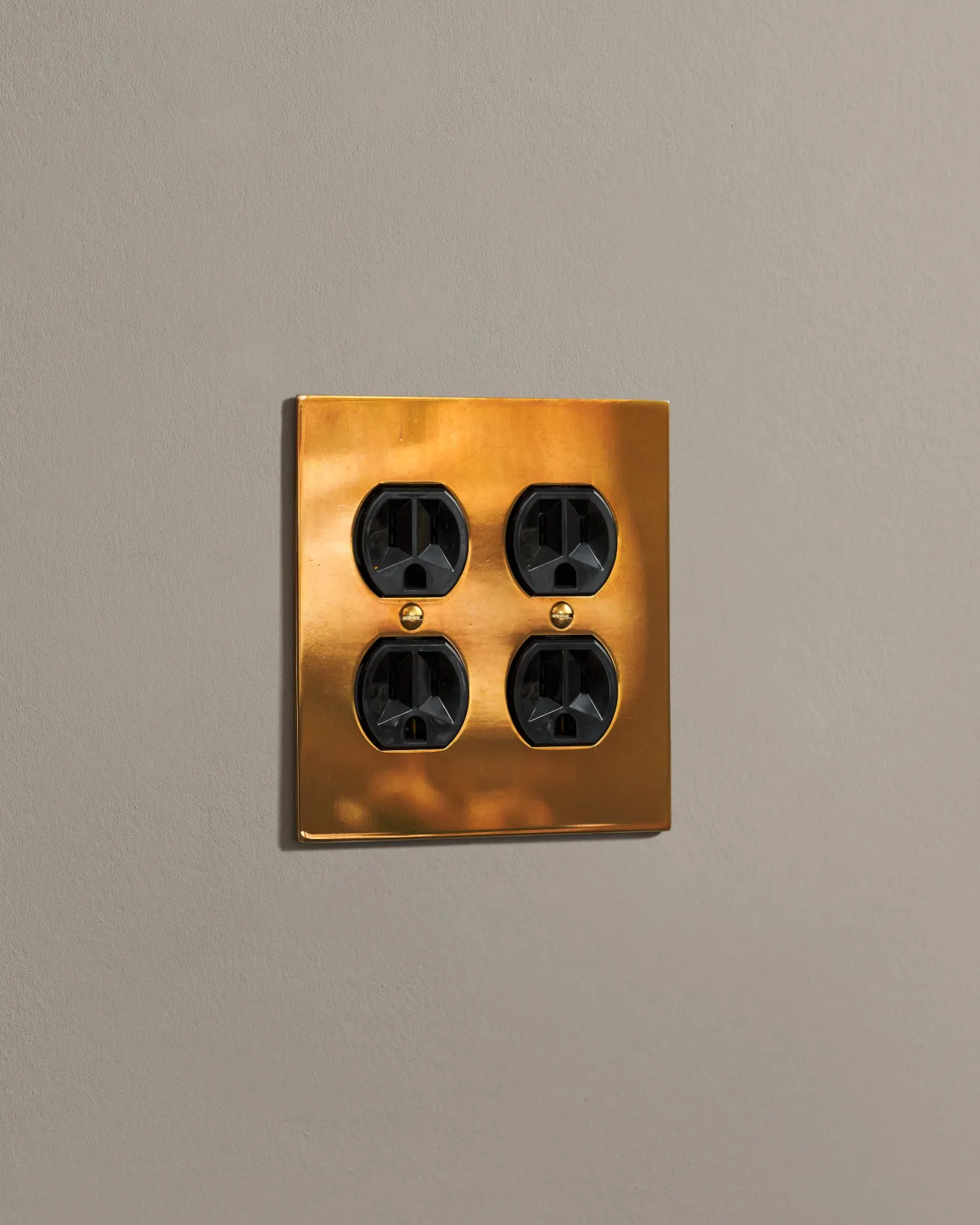 a side on shot of the duplex outlet on an heirloom brass cover plate.