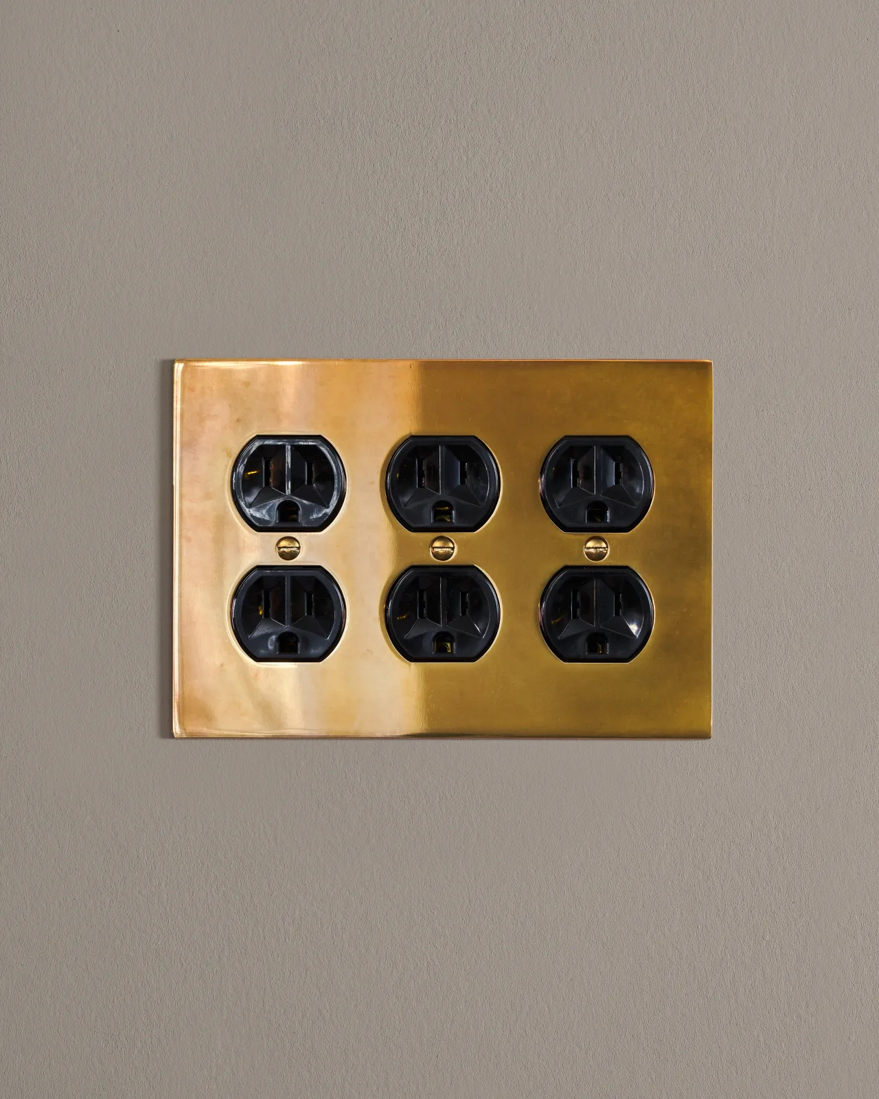 a front on shot of the duplex outlet on an heirloom brass cover plate.