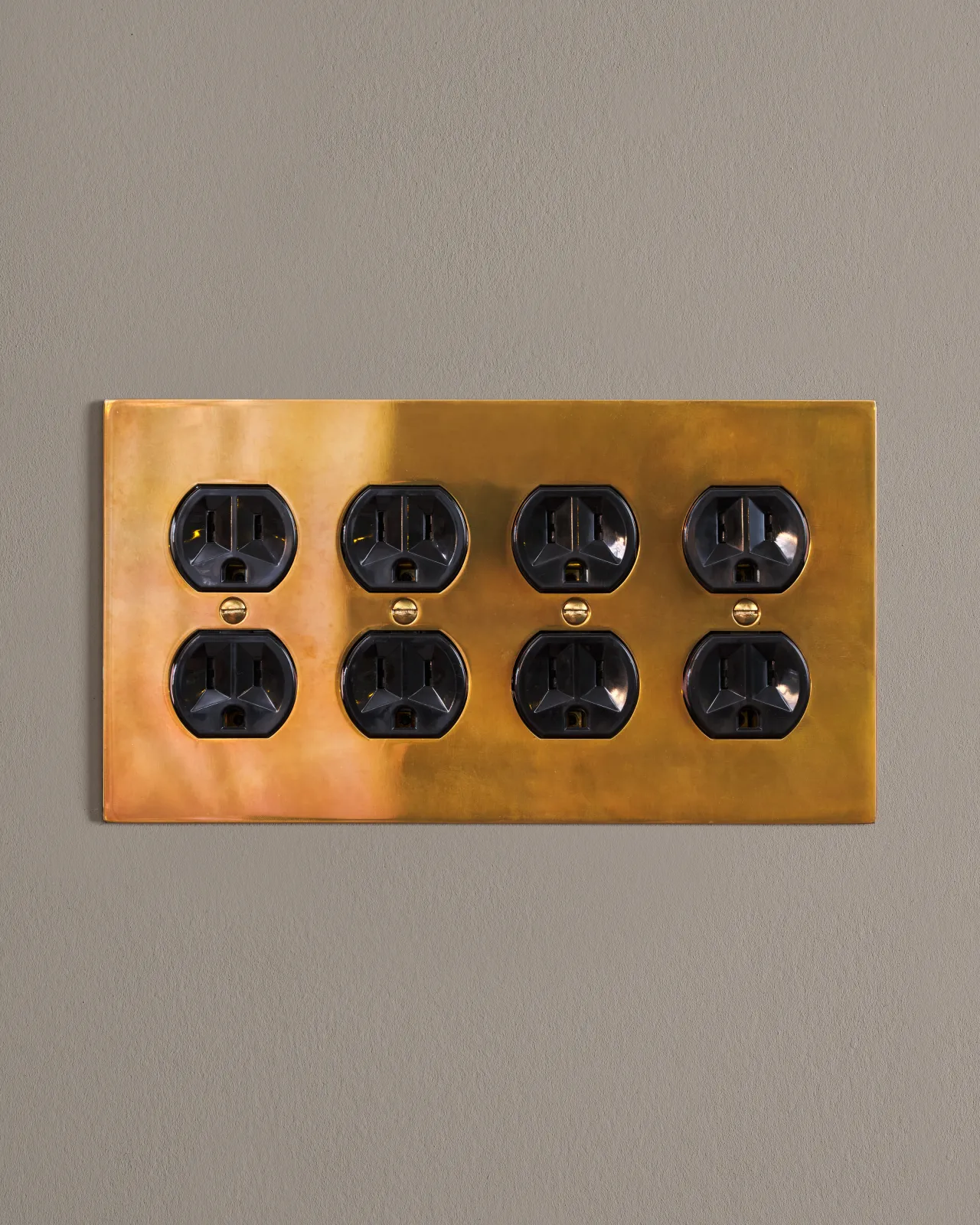 a front on shot of the duplex outlet on an heirloom brass cover plate.