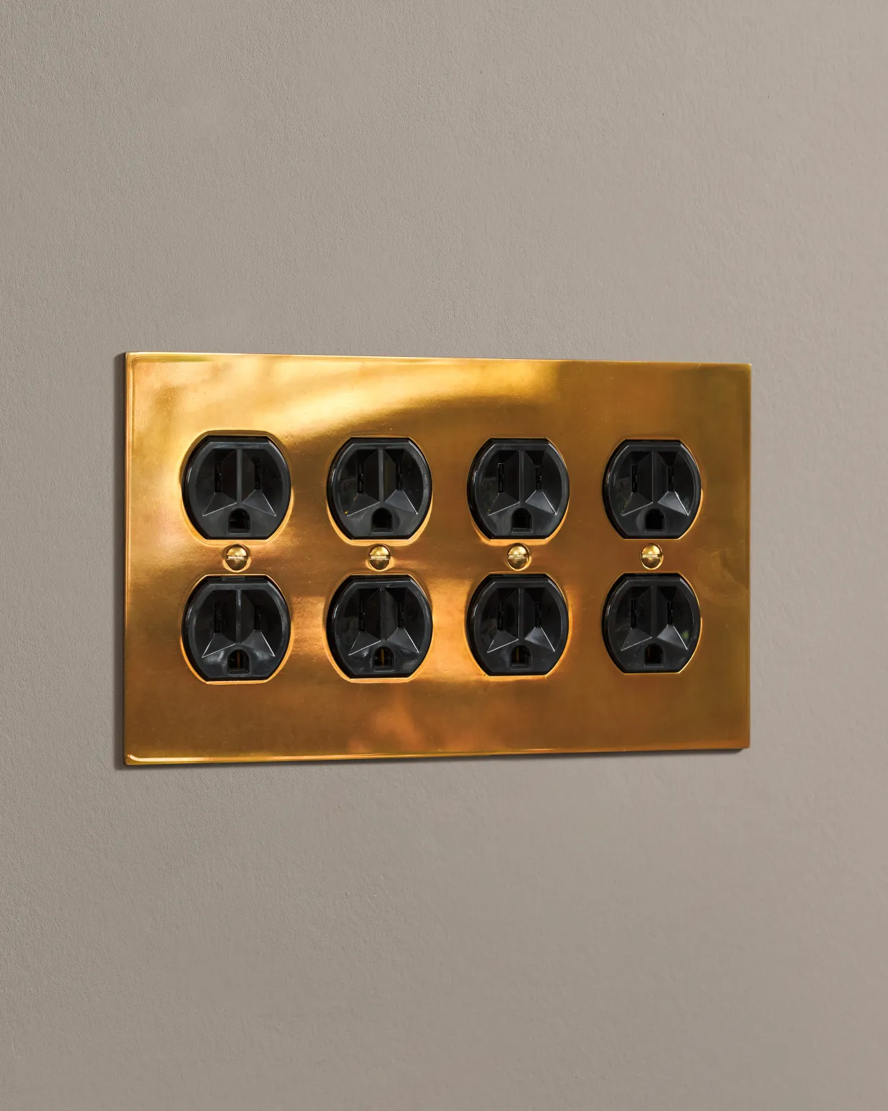 a side on shot of the duplex outlet on an heirloom brass cover plate.