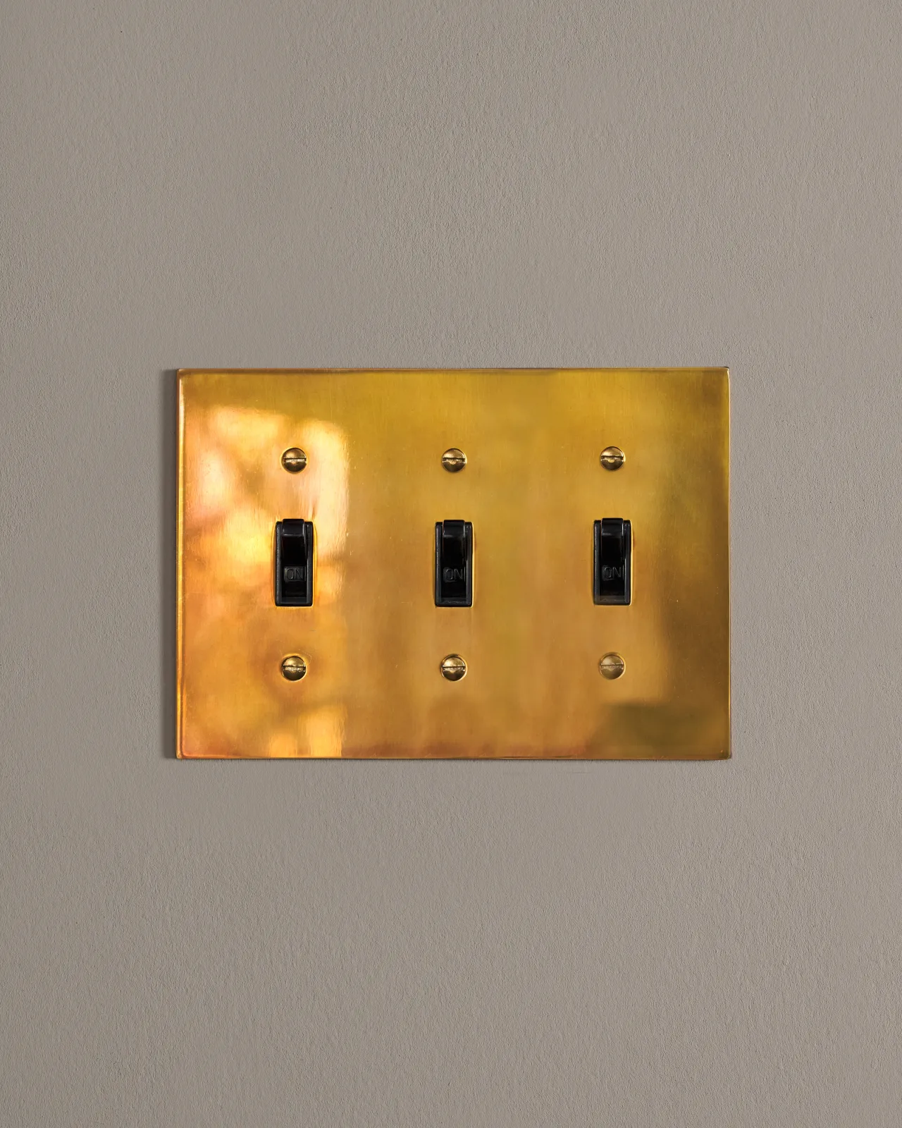 a front on shot of the toggle switch on an heirloom brass cover plate.