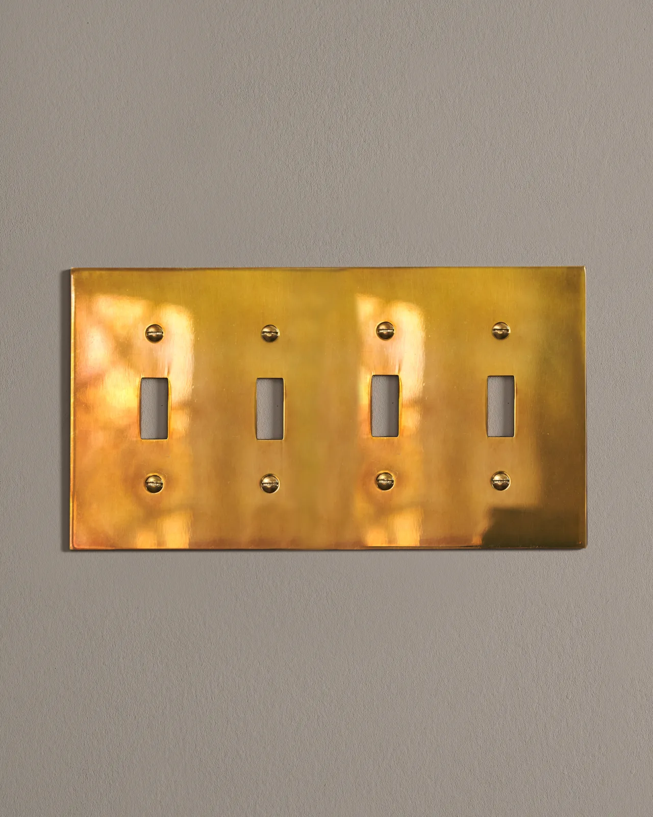 a front on shot of the toggle switch cover plate in heirloom brass.
