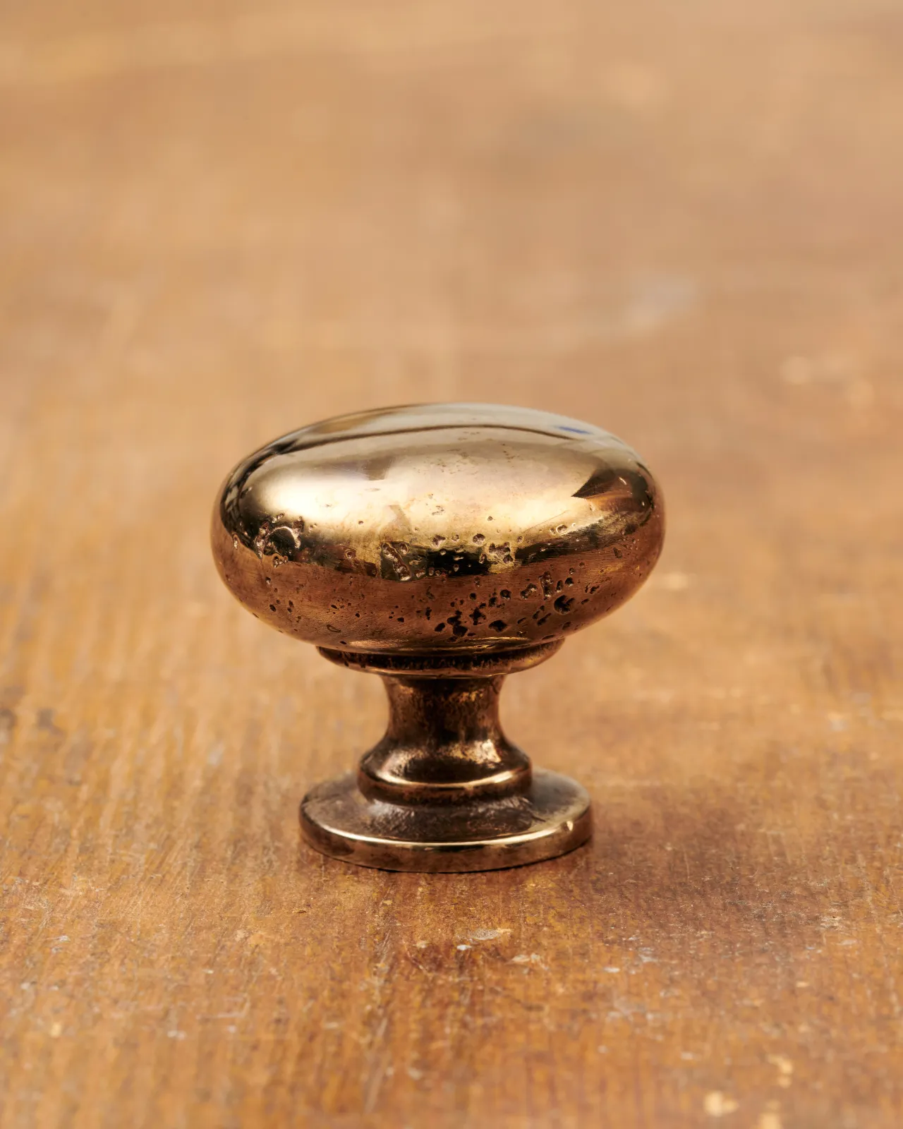A ‘Medium’ classic knob for a kitchen cupboard or drawer with a warm burnished brass finish.