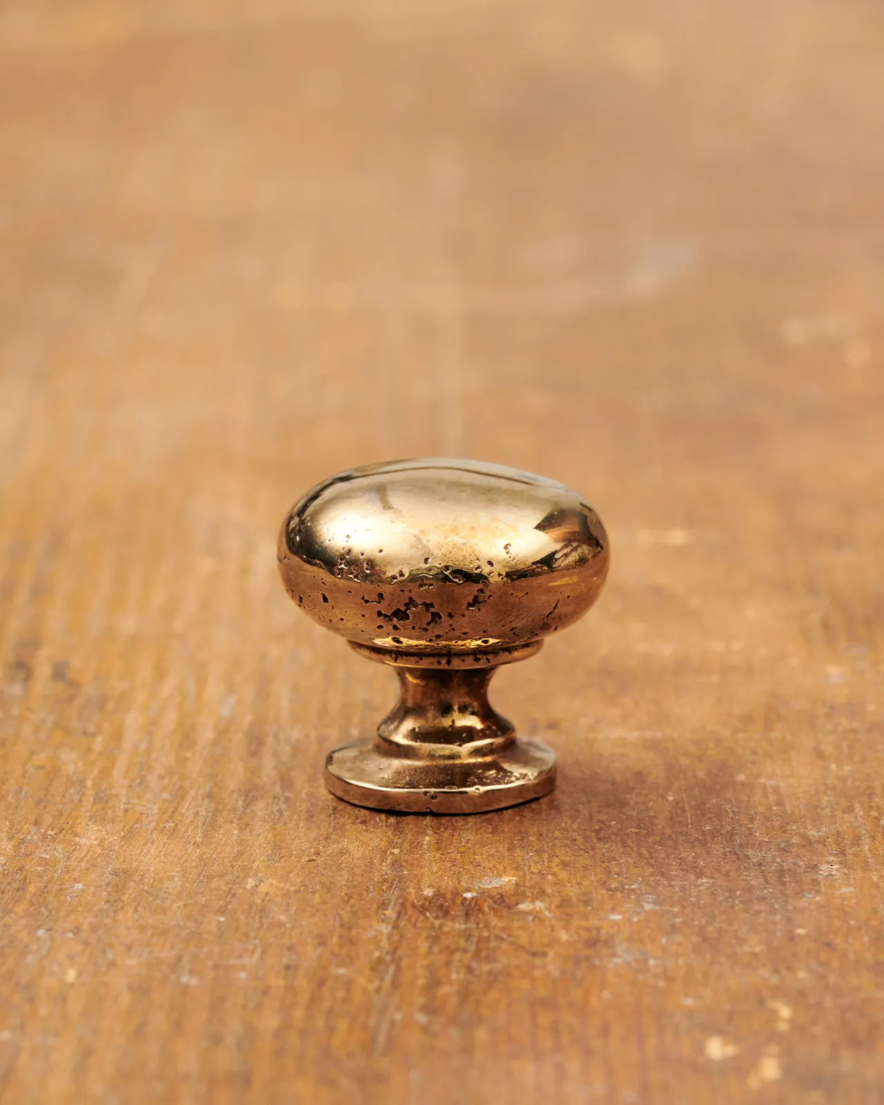 A ‘Small’ classic knob for a kitchen cupboard or drawer with a warm burnished brass finish.