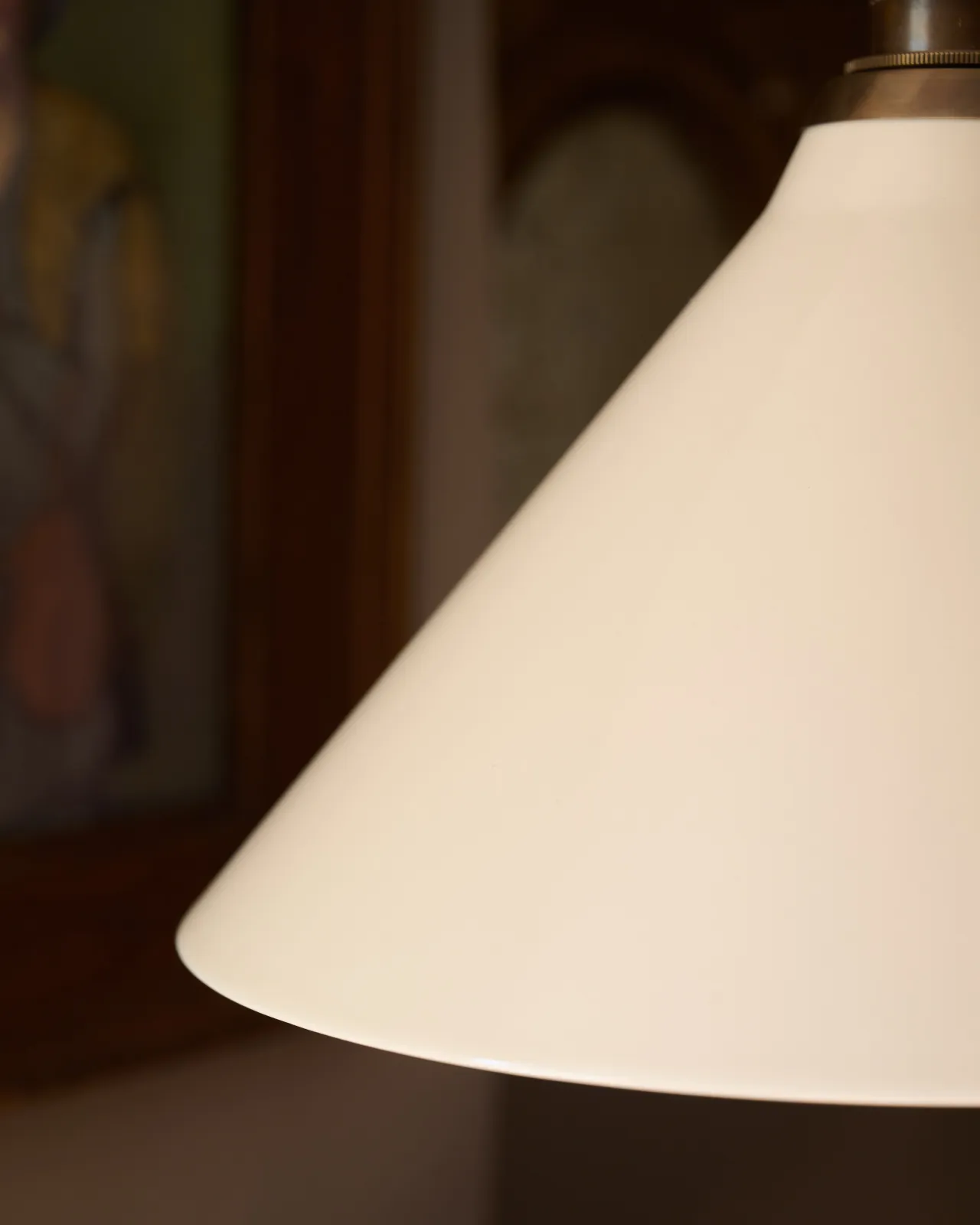 A close-up view of a cream glazed ceramic shade.