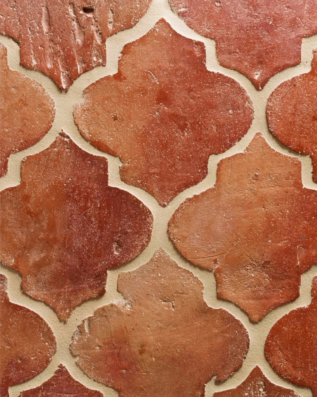 A close-up overhead view of fleur terracotta flooring with an authentic aged finish.