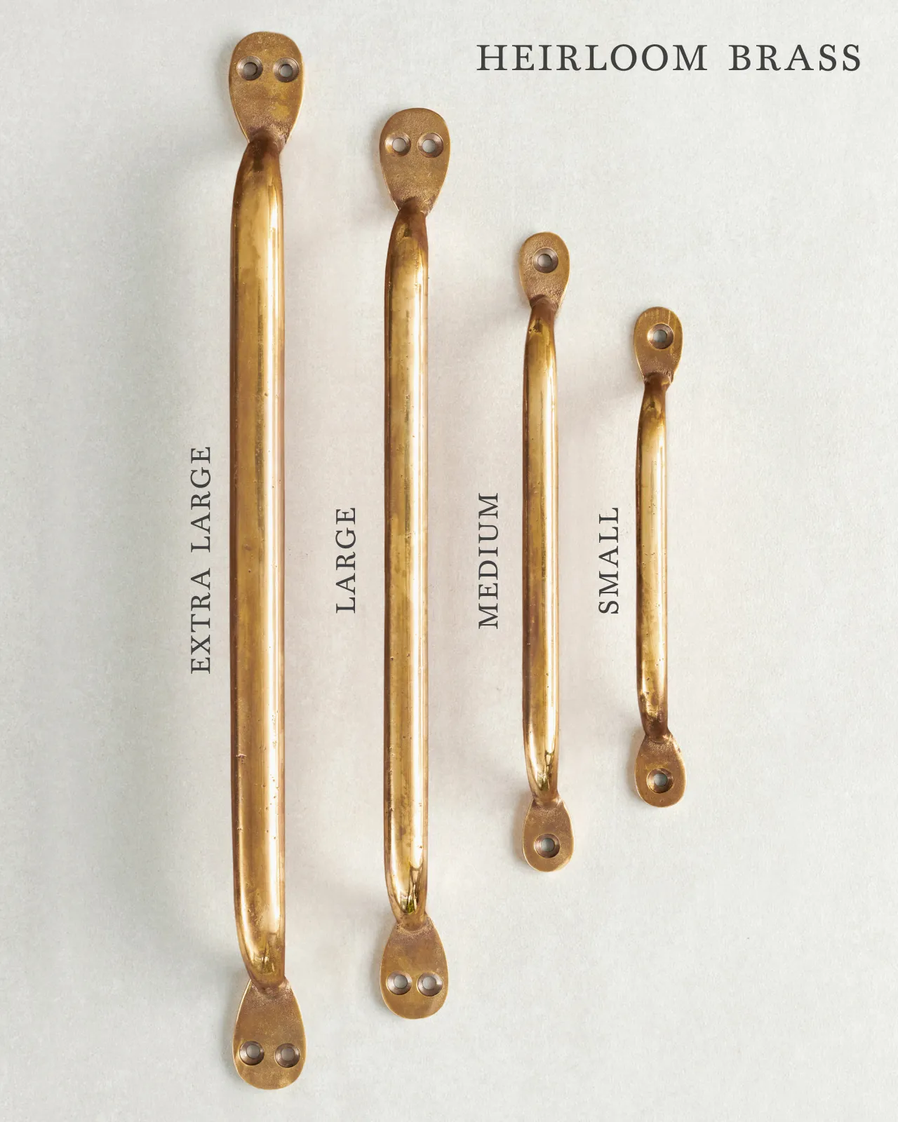 A collection of four classic pull handles for a kitchen cupboard or drawer with a warm burnished brass finish. They range in size from ‘Extra Large’ to ‘Small’.