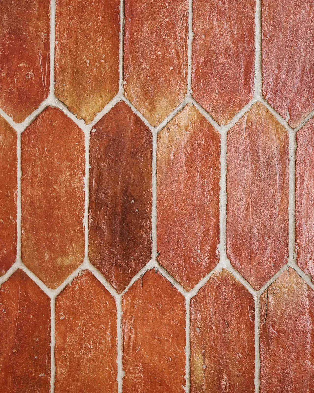 A close-up overhead view of picket terracotta flooring with a rich waxed finish.