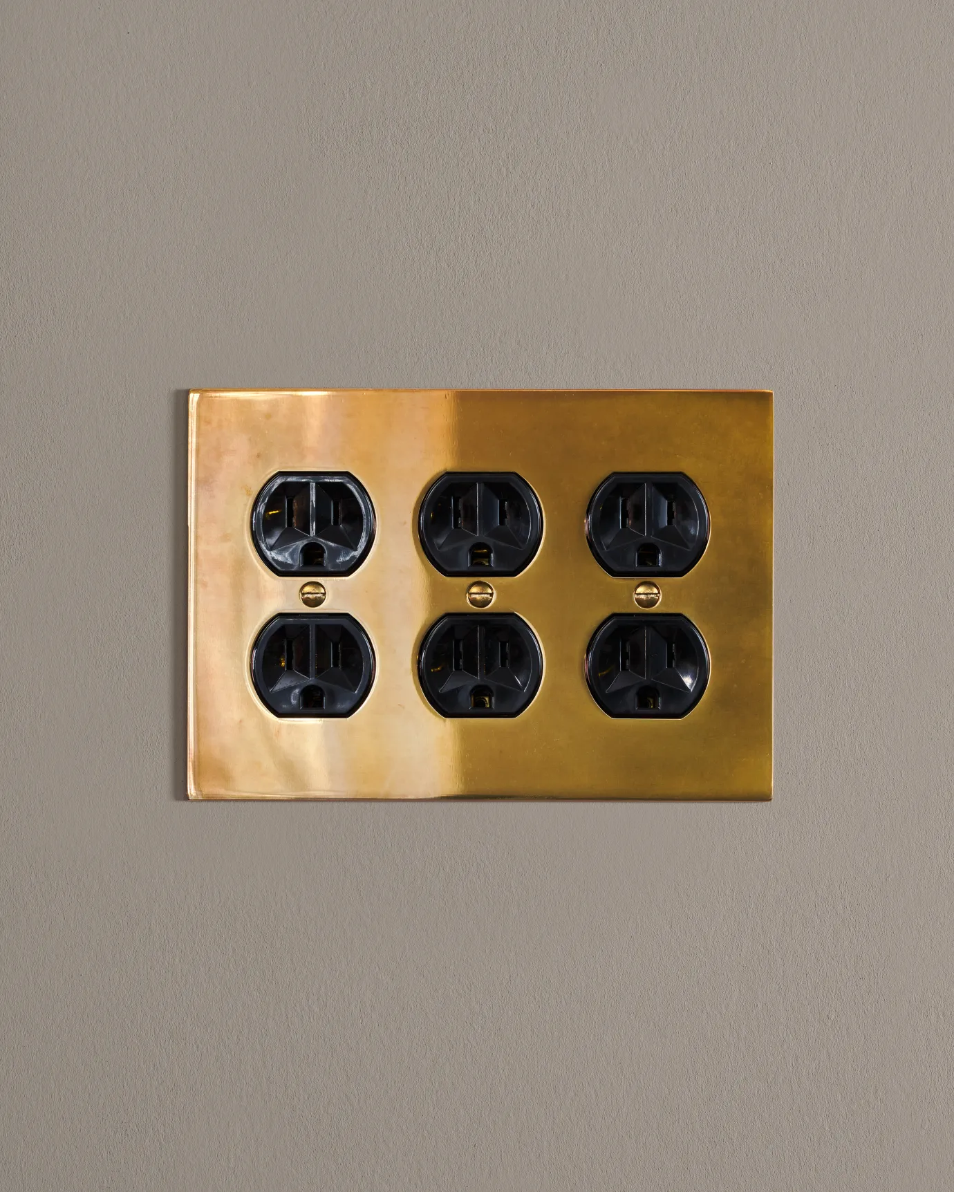 a front on shot of the duplex outlet on an heirloom brass cover plate.