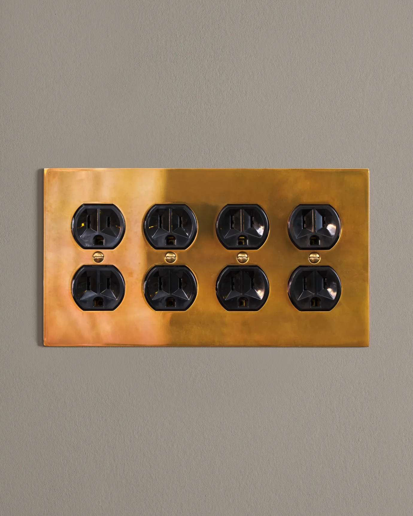 a front on shot of the duplex outlet on an heirloom brass cover plate.