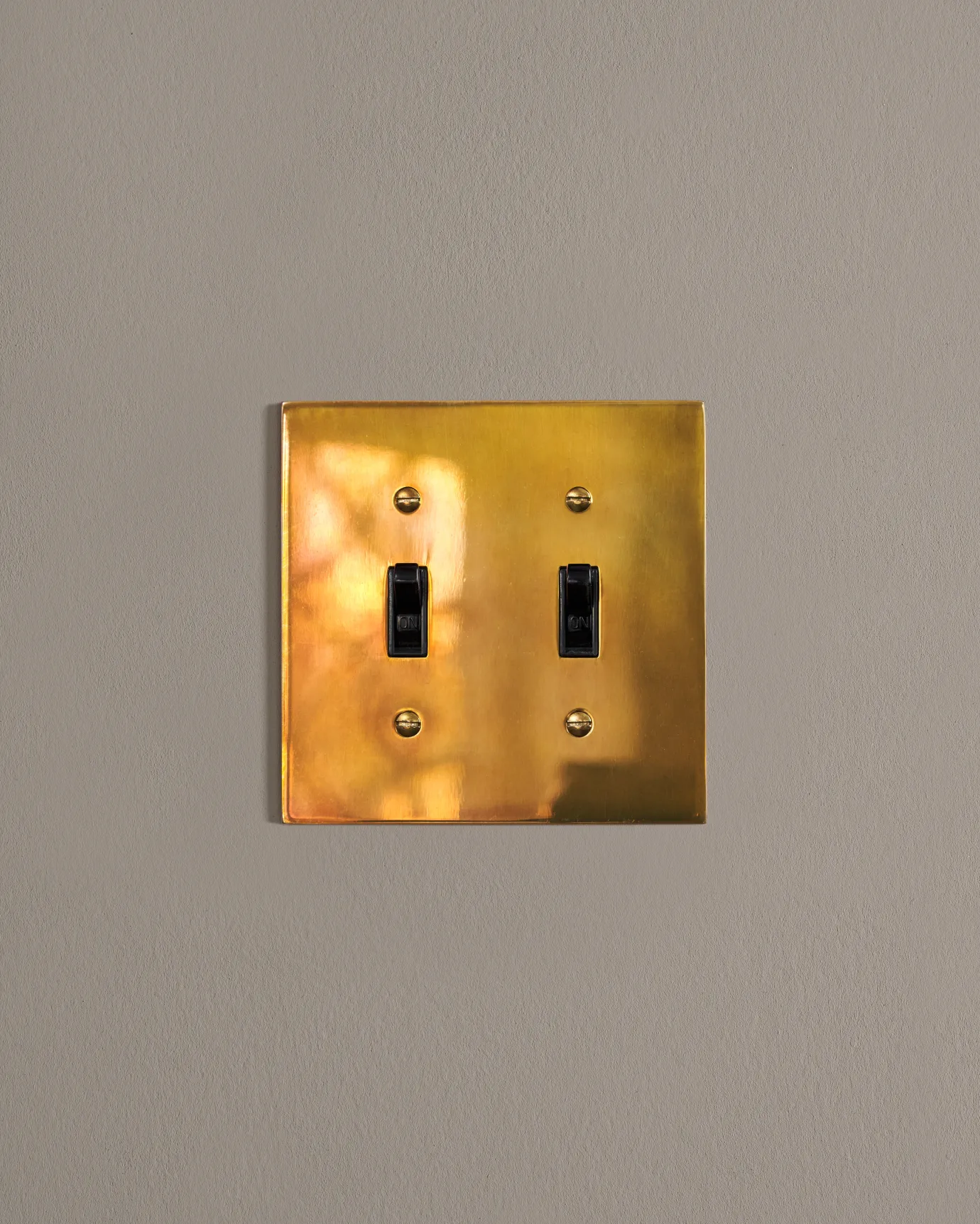 a front on shot of the toggle switch on an heirloom brass cover plate.