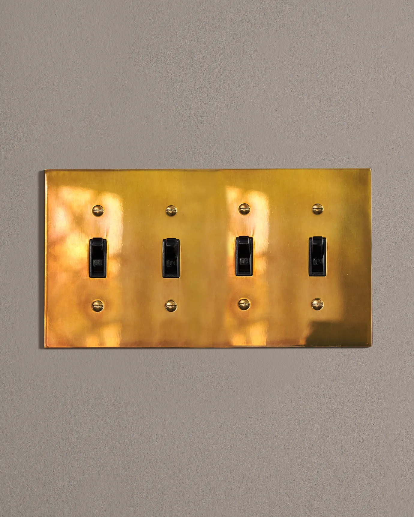 a front on shot of the toggle switch on an heirloom brass cover plate.