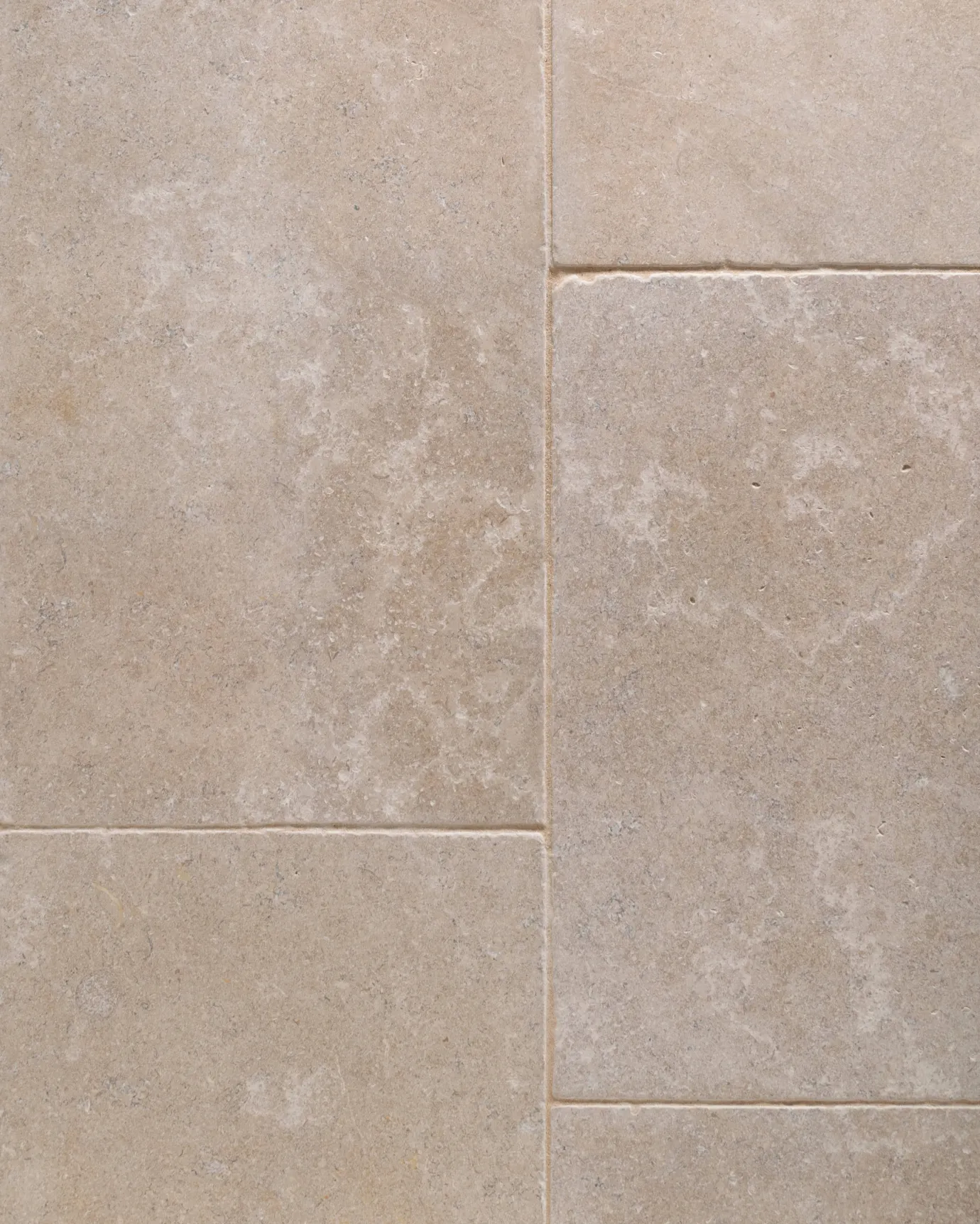 a top down image of the dijon tumbled limestone, looking soft and warm cream, showing the flooring layout.